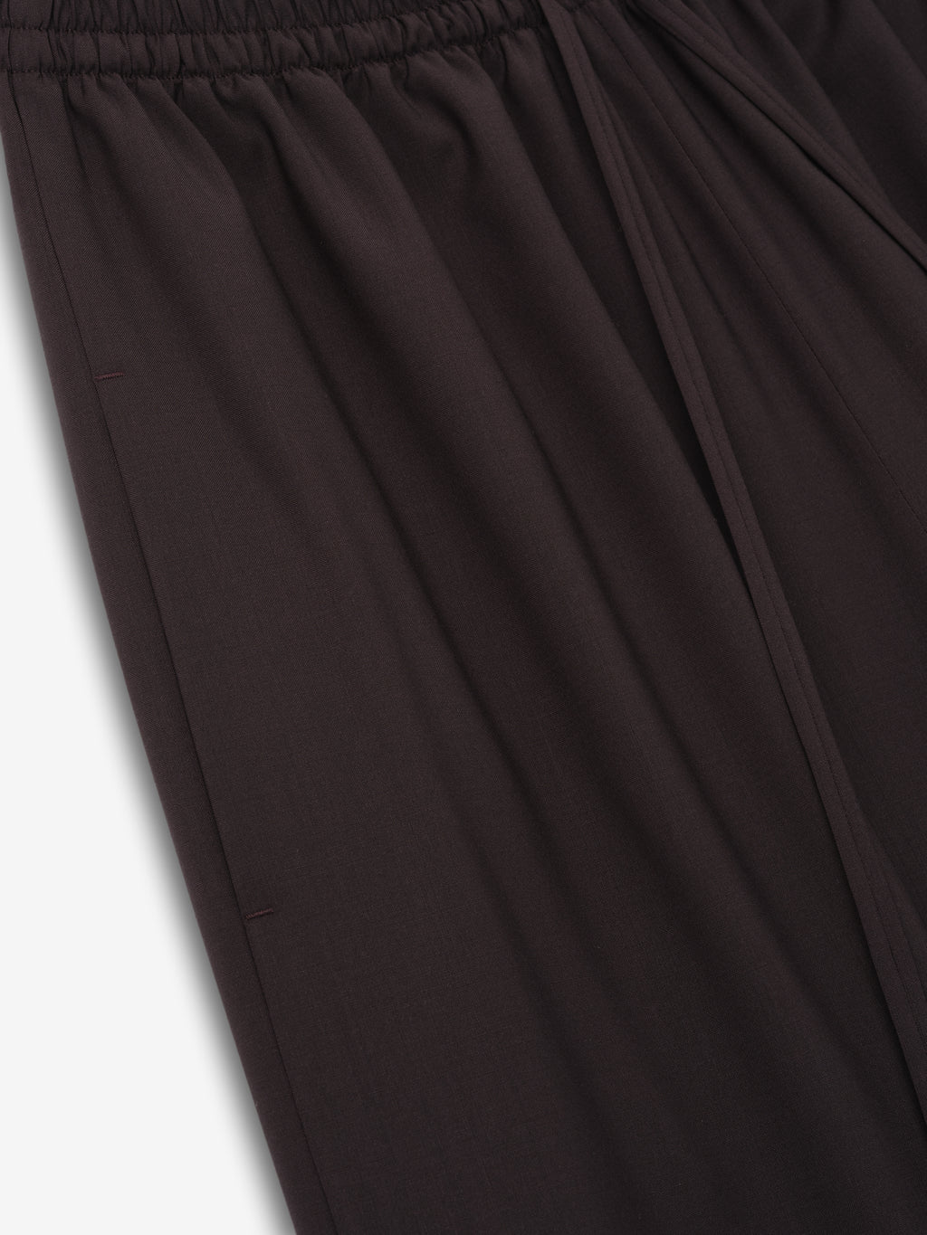 close-up of dark superfine wool canvas drawstring pants with elasticated waistband and relaxed wide-leg fit for women