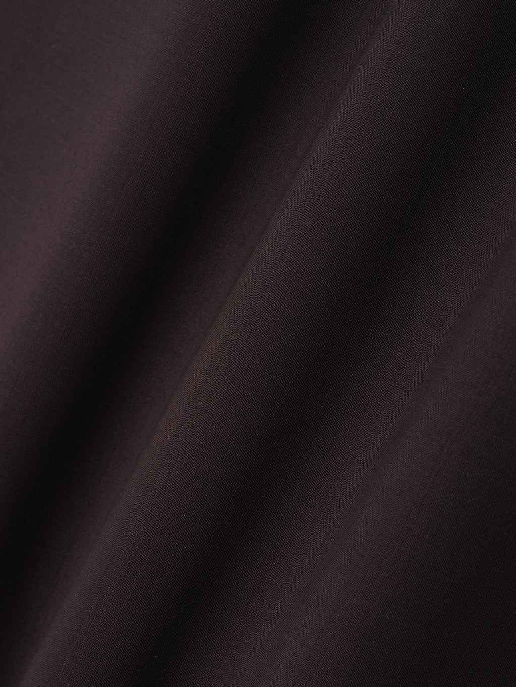 close-up of dark superfine wool canvas fabric with smooth texture and soft drape detail