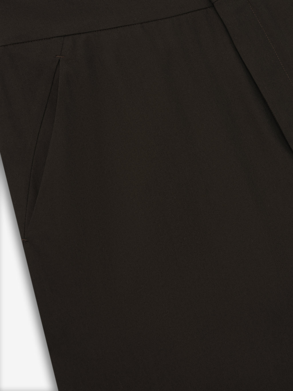 close-up of dark brown womens worker pants showcasing smooth fabric and side slit pocket detail on neutral background