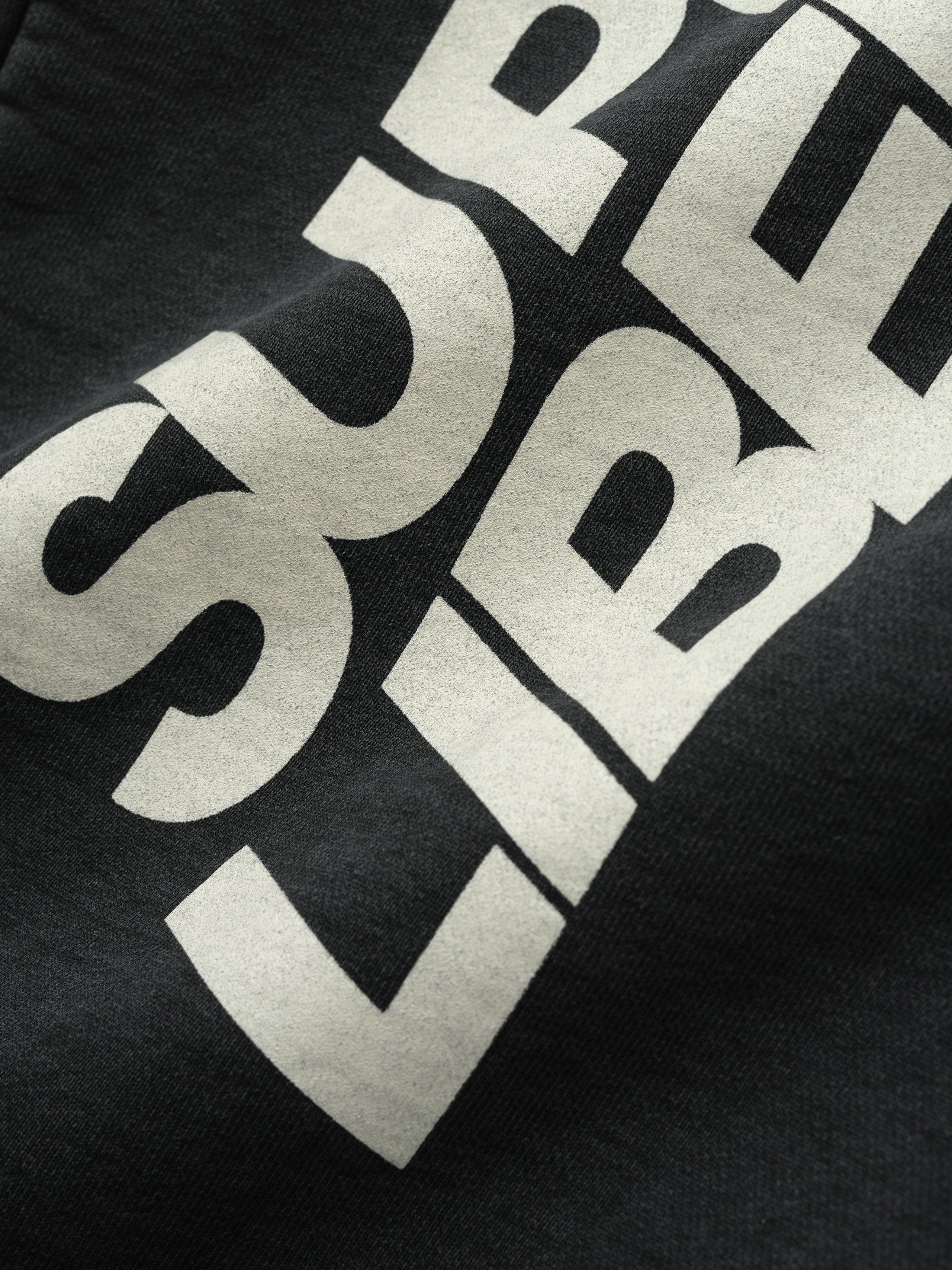 Close-up of black DSYF Wide Leg Sweatpant showing bold white text detail in gallery image zero FGDSYF-FLC006U.