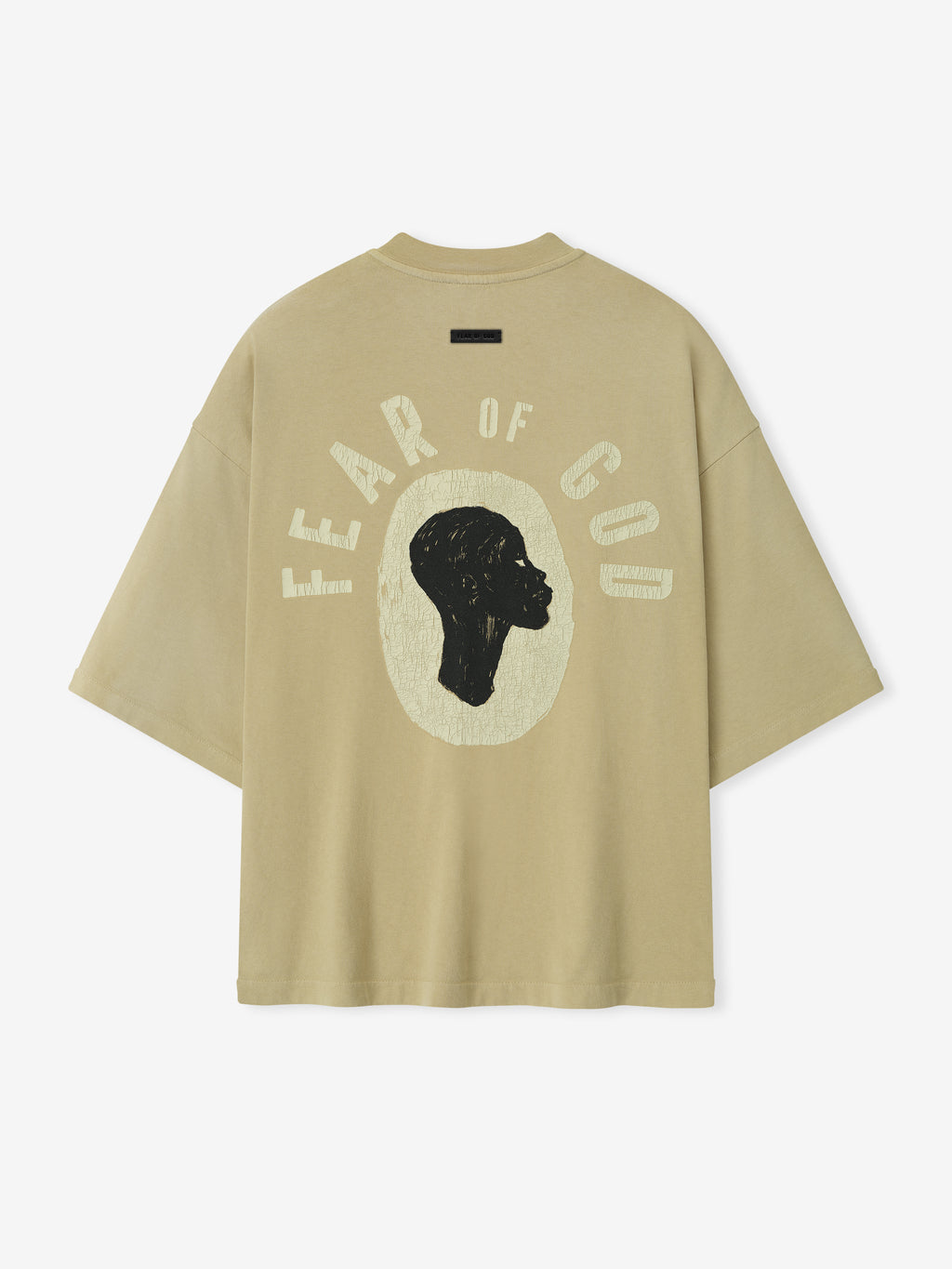Back view of clay Liberation Now Tee featuring black profile silhouette and textured pale yellow FEAR OF GOD text centered on fabric