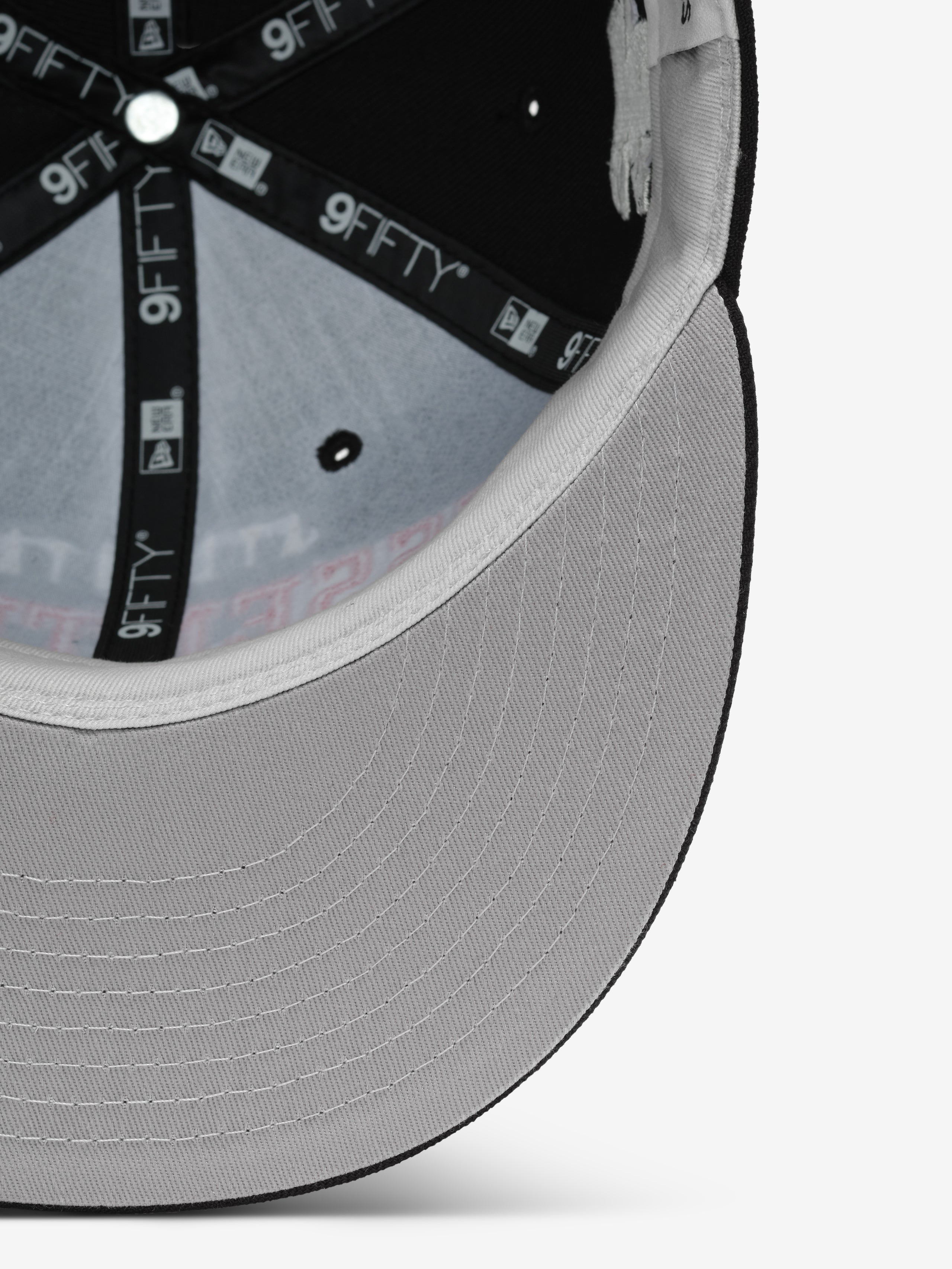 Close-up inside view of Falcons 9Fifty RC Snapback showing grey underbill and branded 9FIFTY taping, gallery image 0