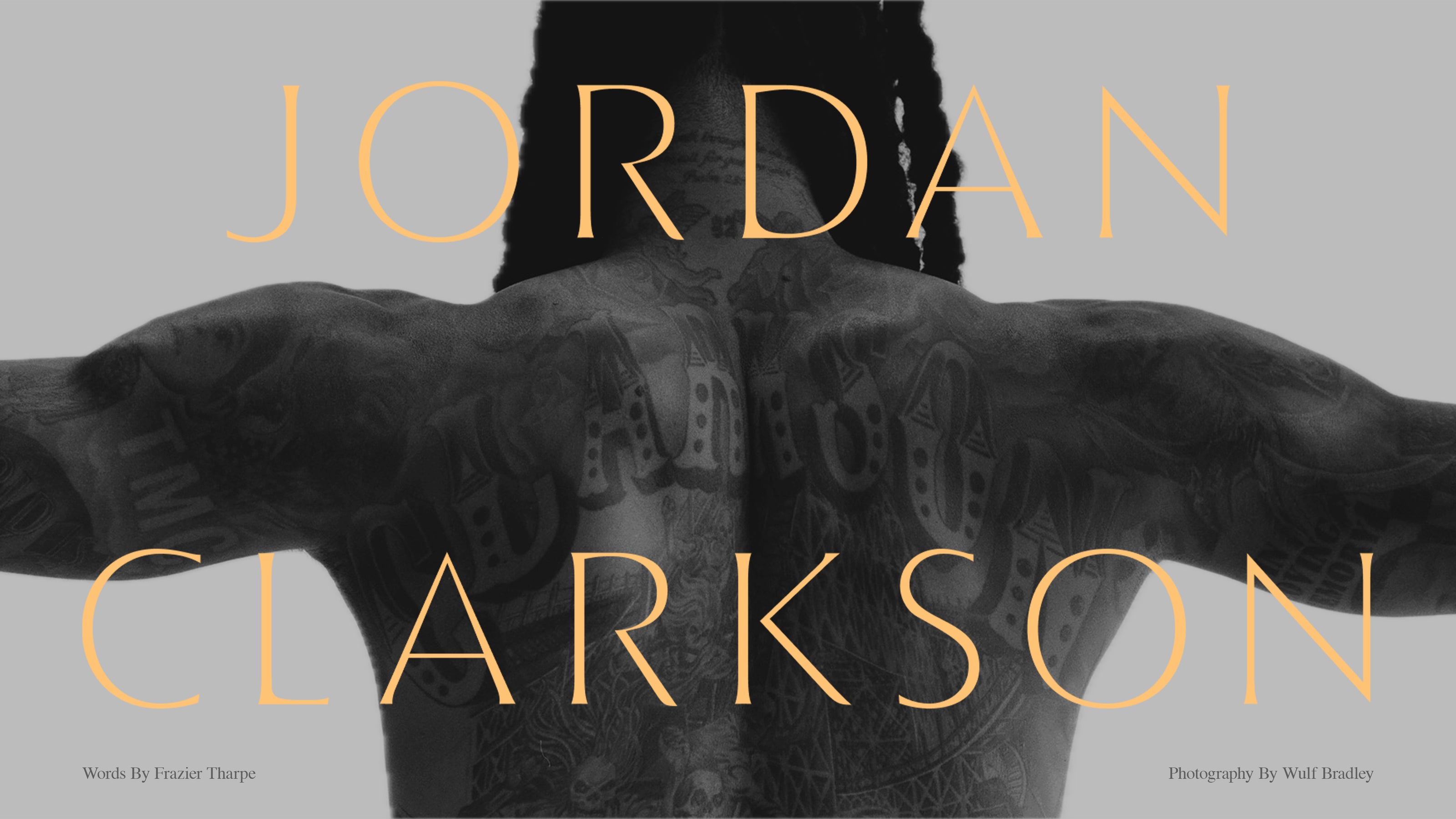 Grayscale editorial image of Jordan Clarkson showing his tattooed back and outstretched arms with large gold Jordan Clarkson lettering and small photo credits