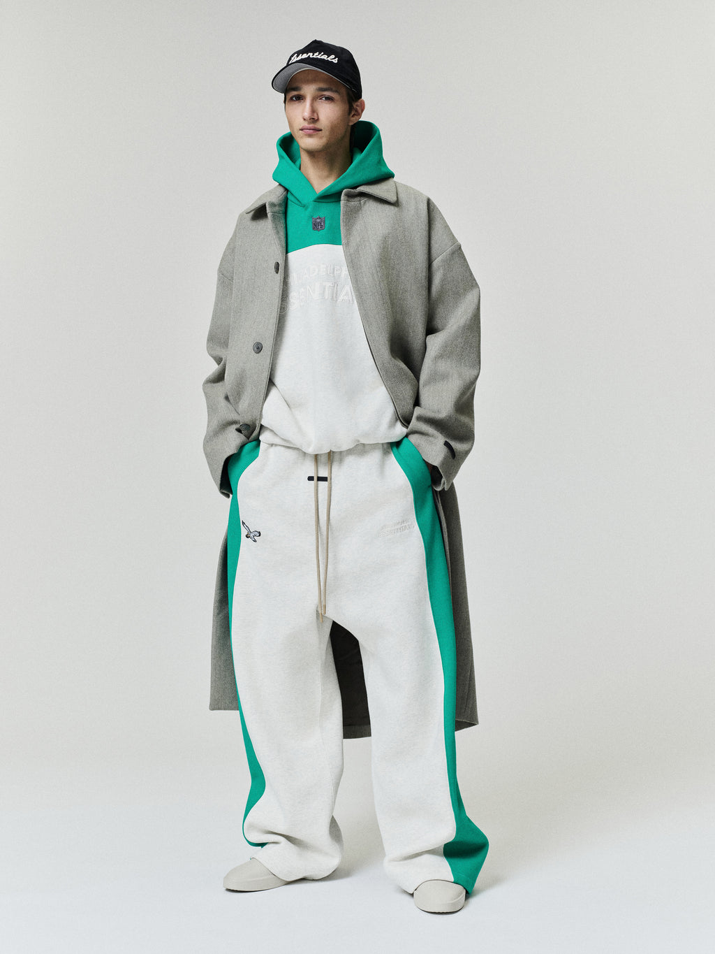 Eagles Lounge Sweatpant in white fleece with green side panels and drawcord waist styled on a model as a Bottoms product view