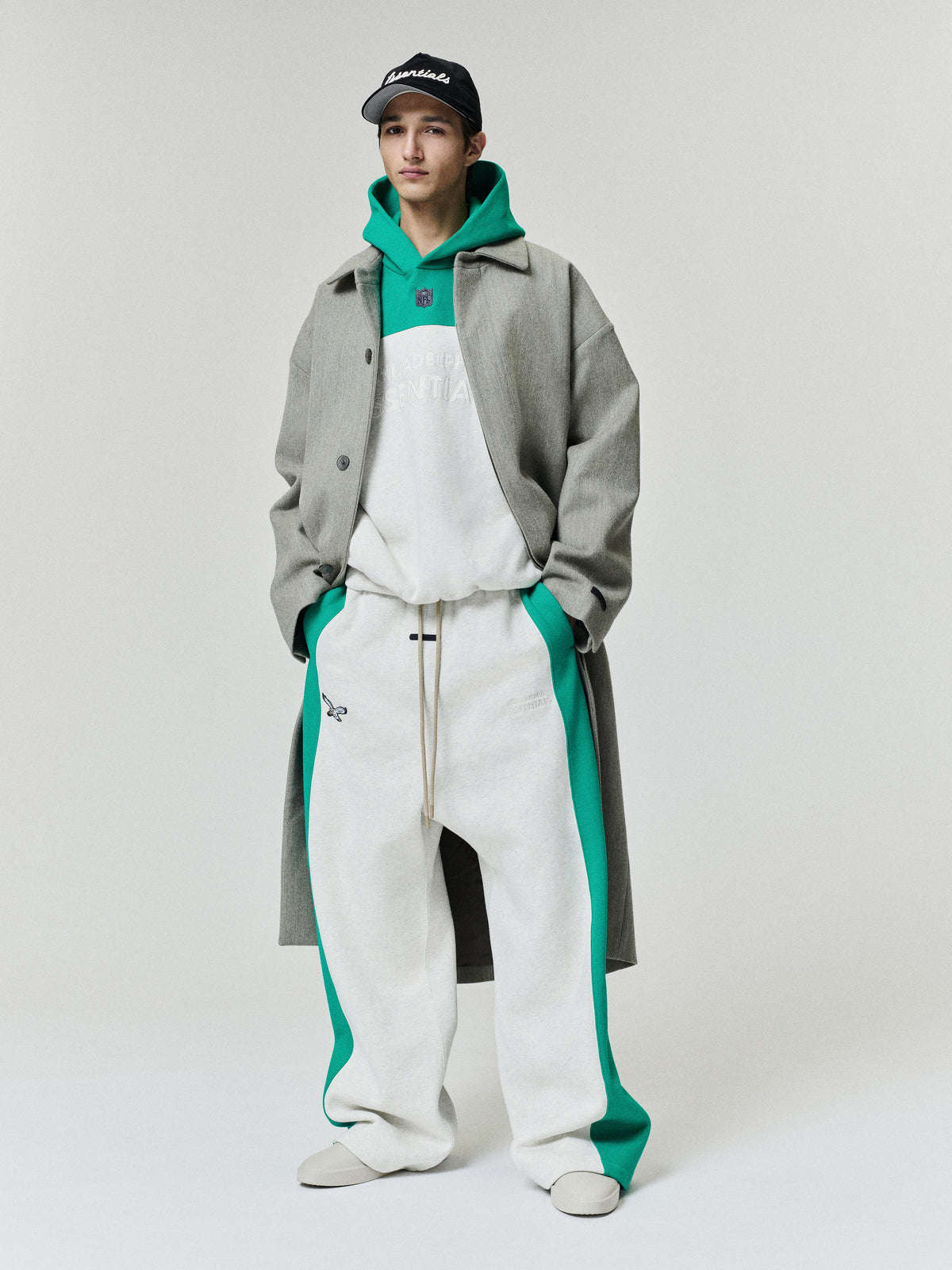 Eagles Lounge Sweatpant in white fleece with green side panels and drawcord waist styled on a model as a Bottoms product view