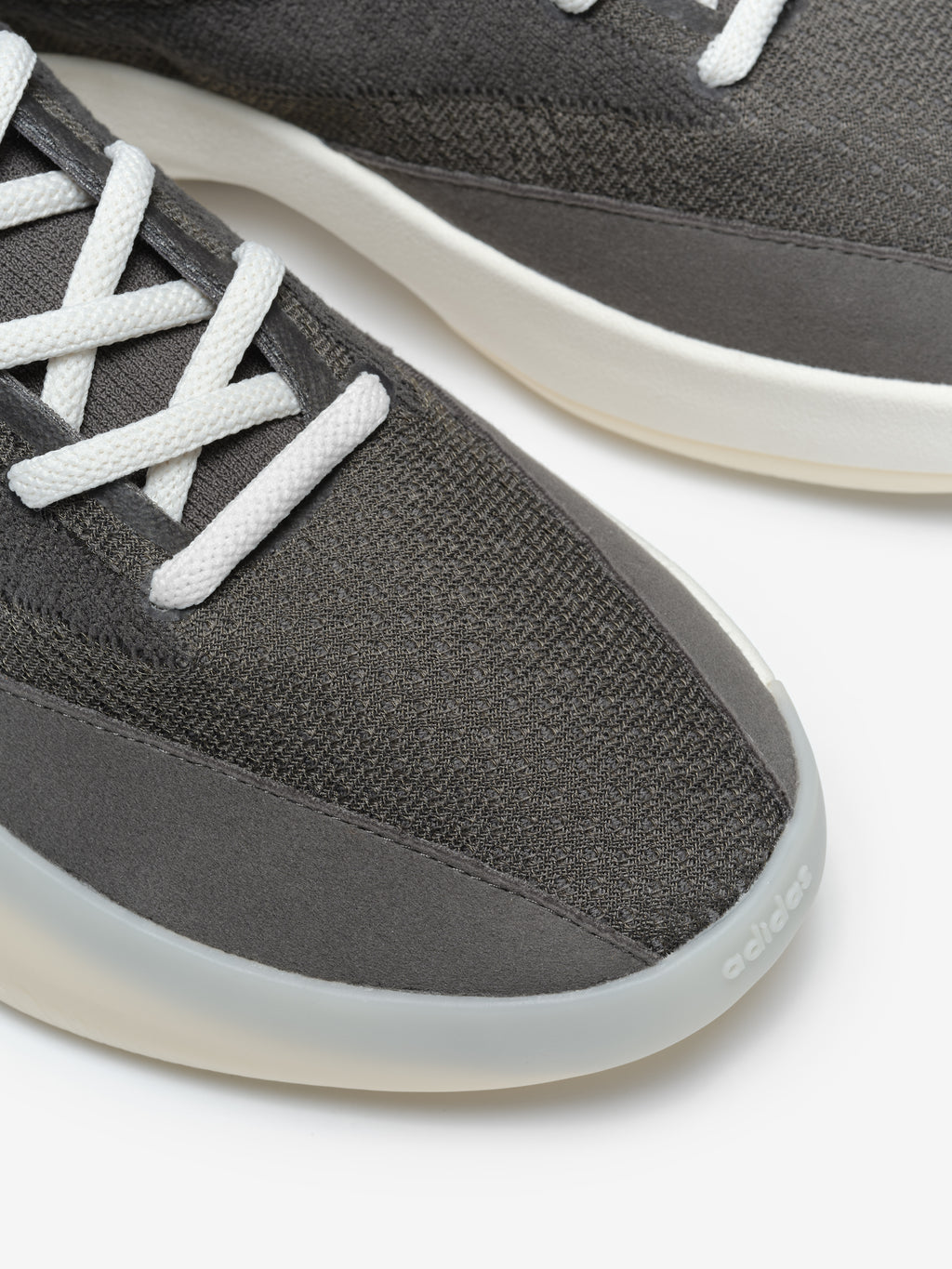 Athletics III Basketball footwear featuring a dark gray knit upper with suede overlays, white laces, and a smooth off-white sole with a rounded toe for a modern athletic look.