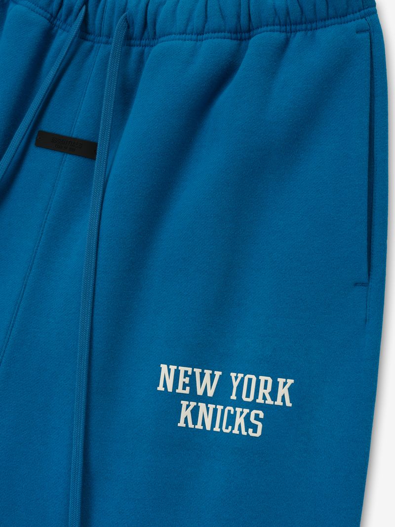 Close-up of blue Knicks Lounge Sweatpant showing front pocket and white NEW YORK KNICKS text on thigh area LYvqXwiA.jpg