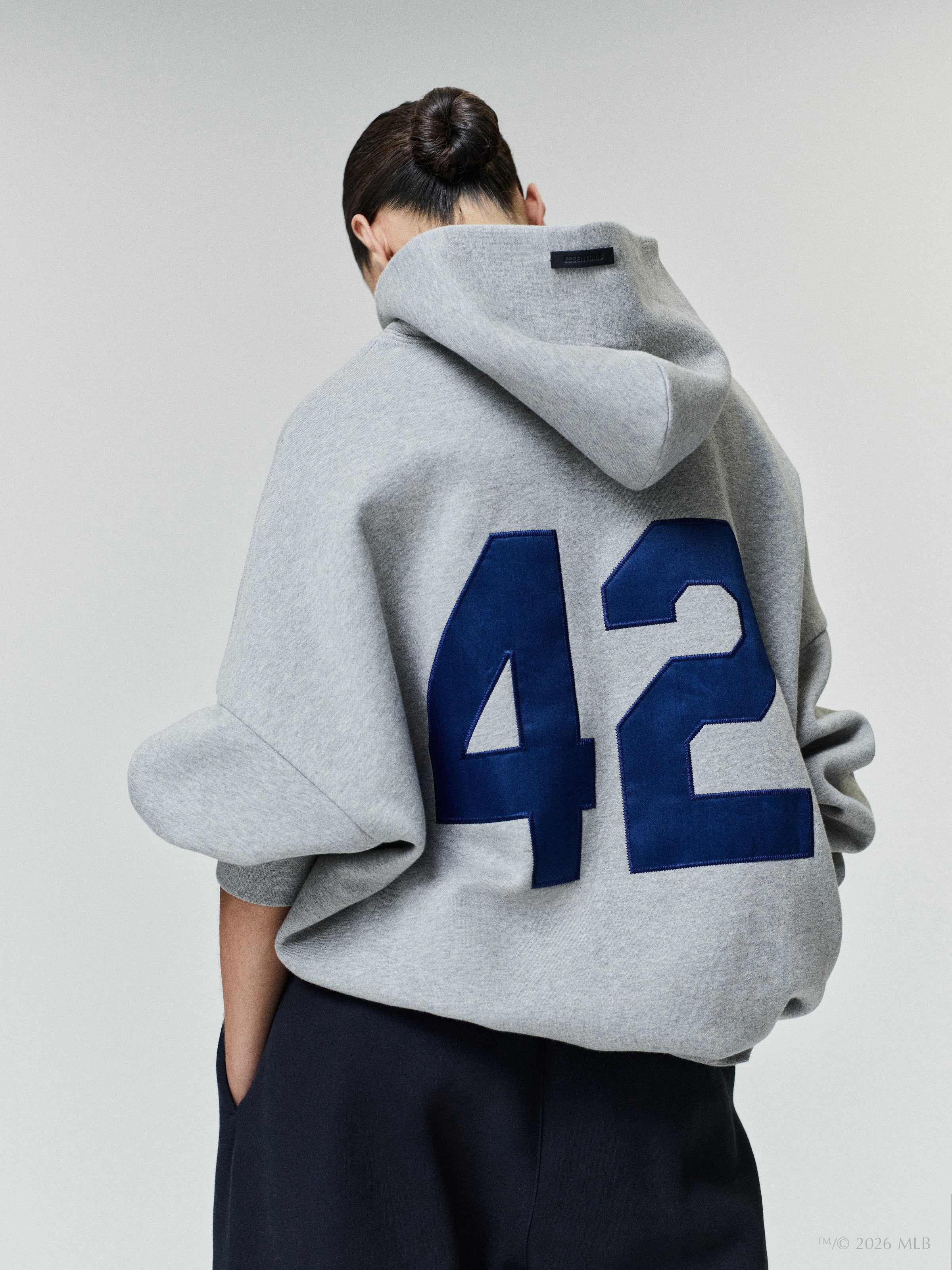 Back view of a gray oversized hoodie featuring large blue number "42" printed on the back panel