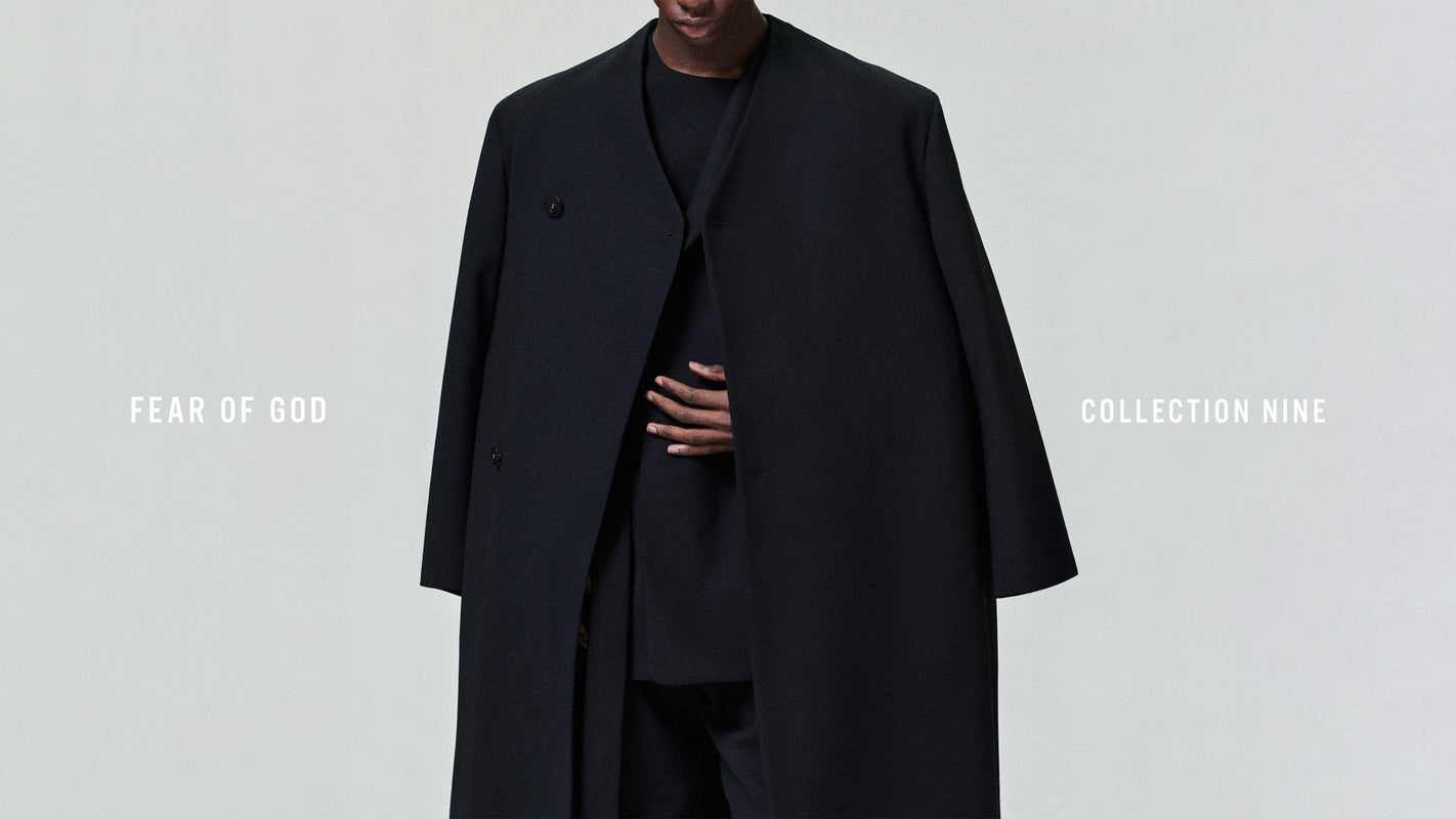 Person wearing a black coat with 'Fear of God Collection Nine' text on a white background