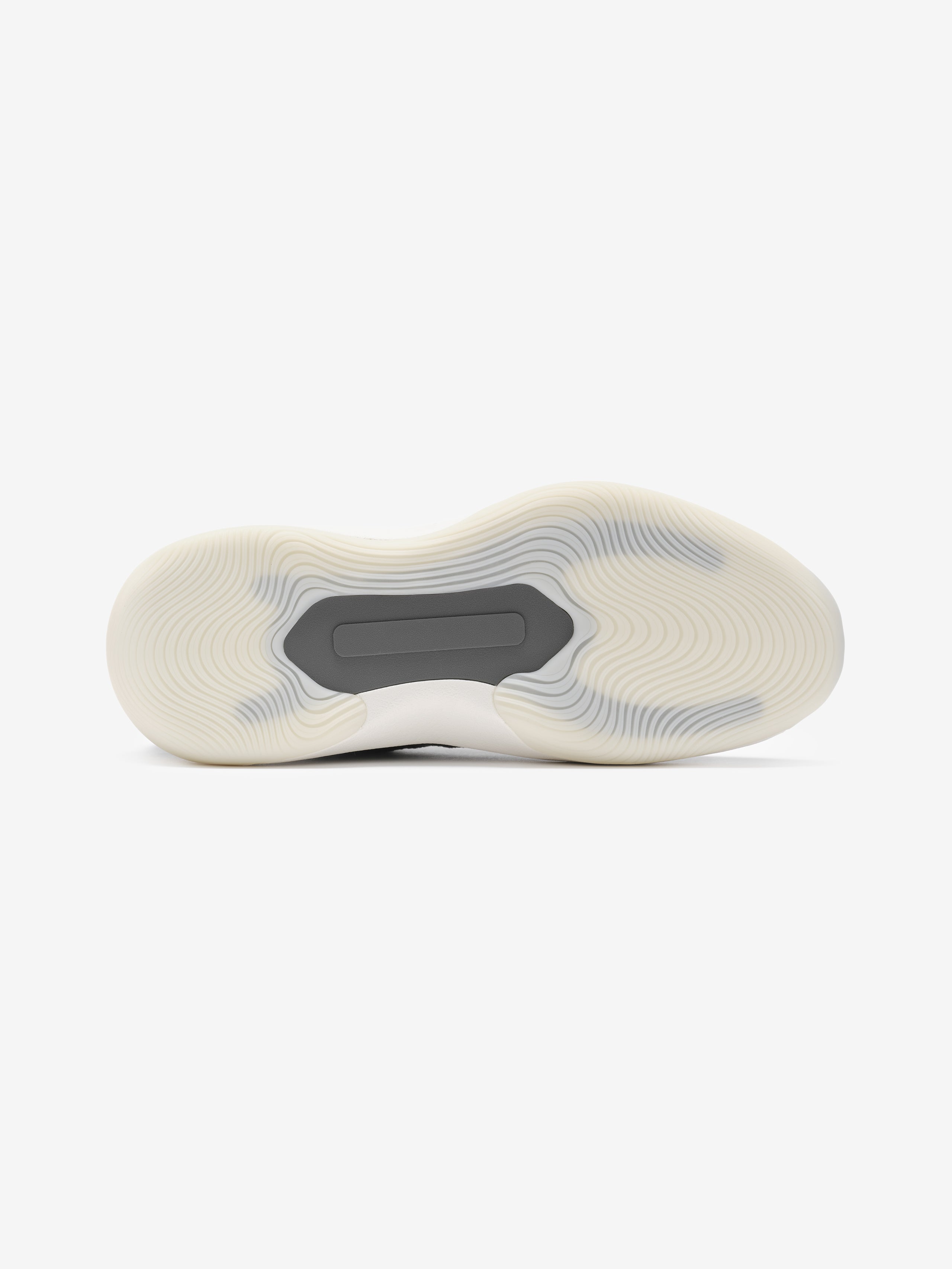 White sneaker with a gray sole on a white background