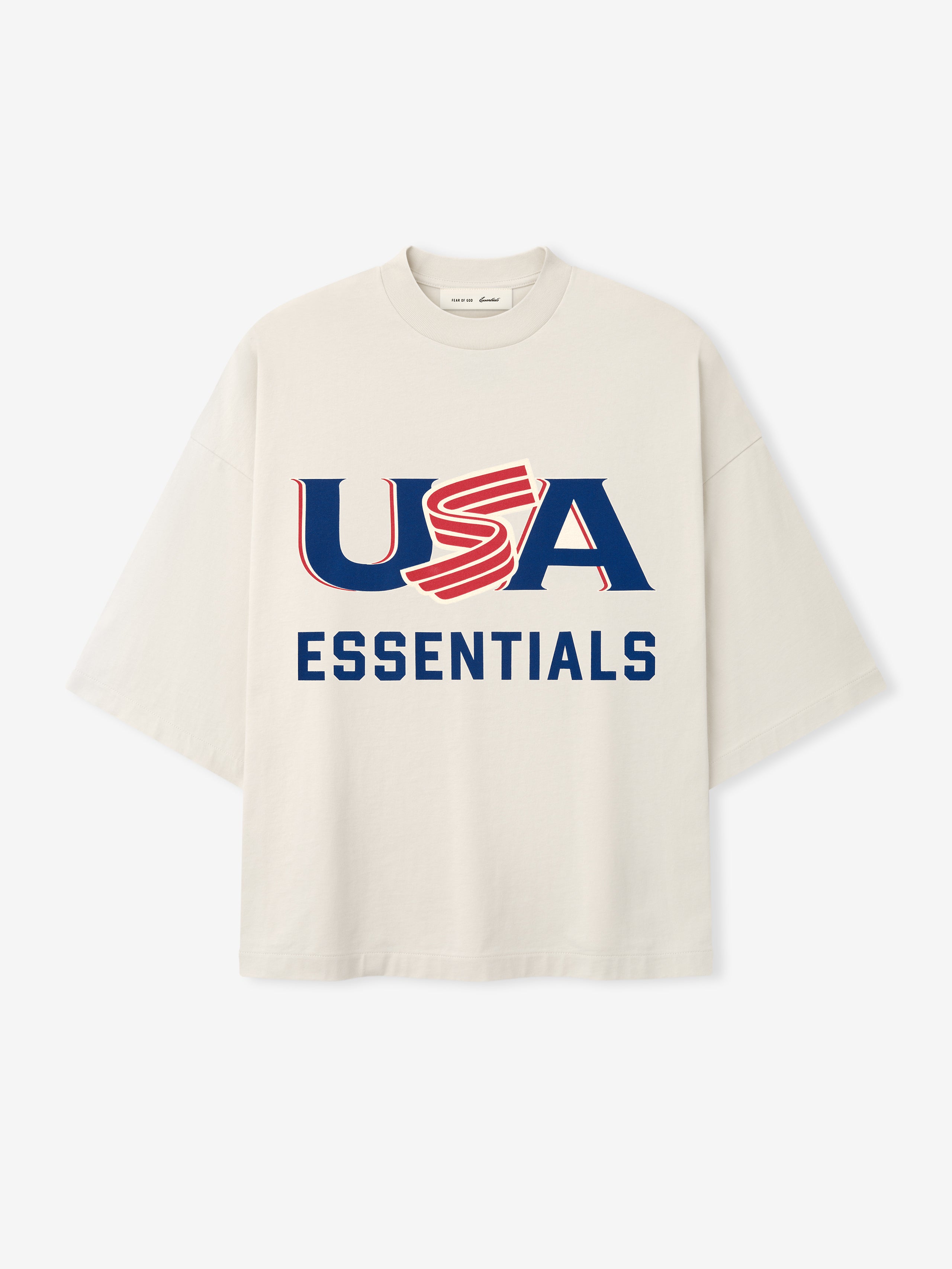 Cream oversized short-sleeve T-shirt with bold navy and red "USA ESSENTIALS" graphic on front center