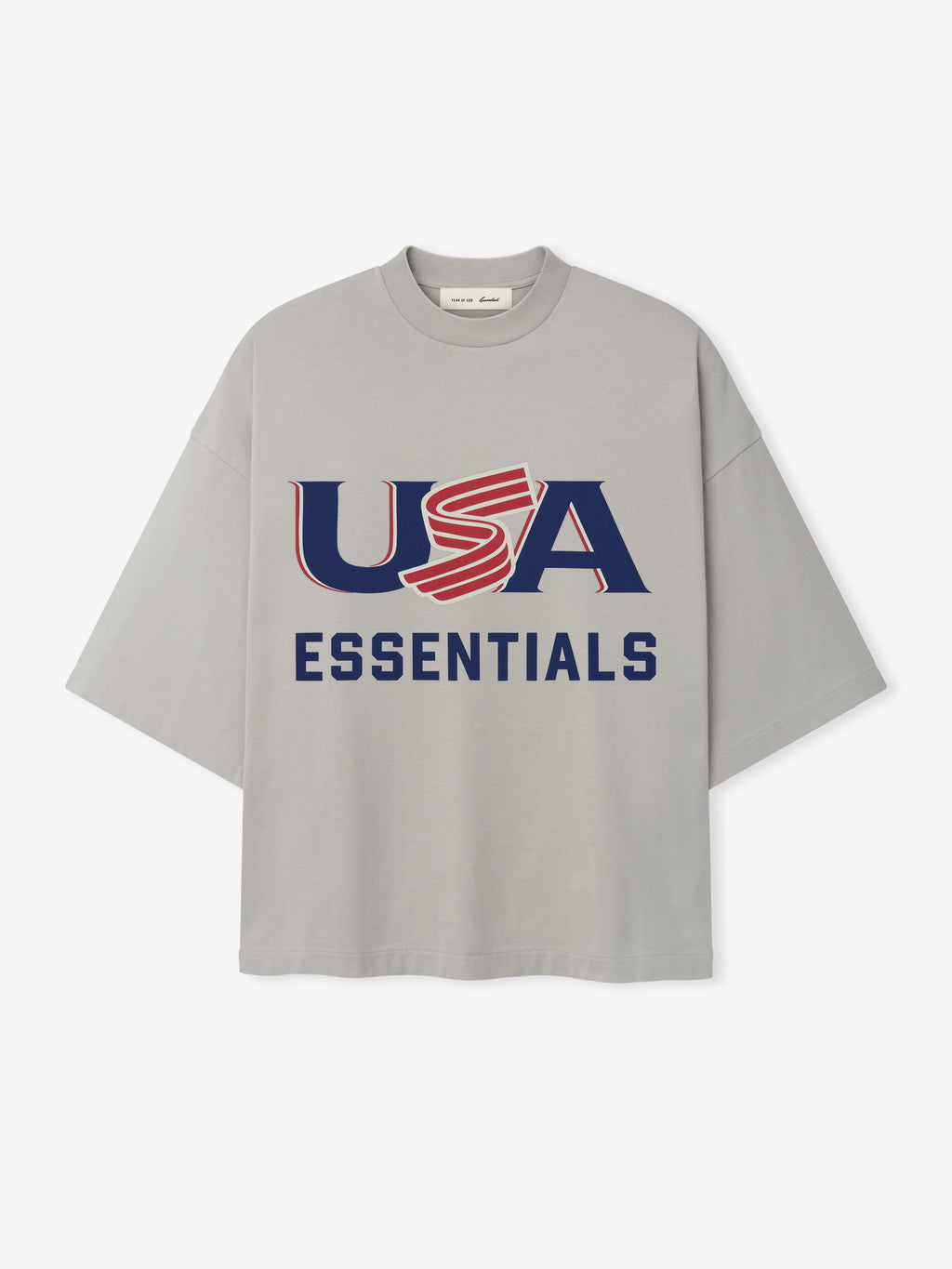 Light gray oversized short-sleeve T-shirt with navy and red "USA ESSENTIALS" graphic on front center