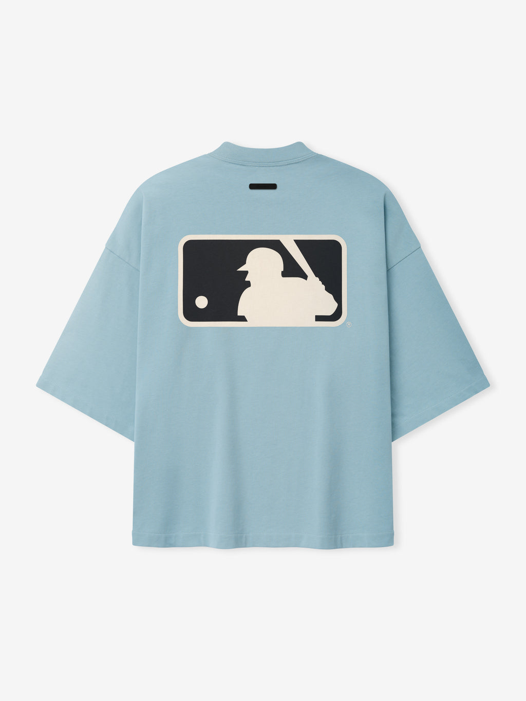 Mlb Merch Tee in soft stone blue with an oversized fit, featuring a large vintage-style baseball batter graphic in cream and navy on the back of a casual top.