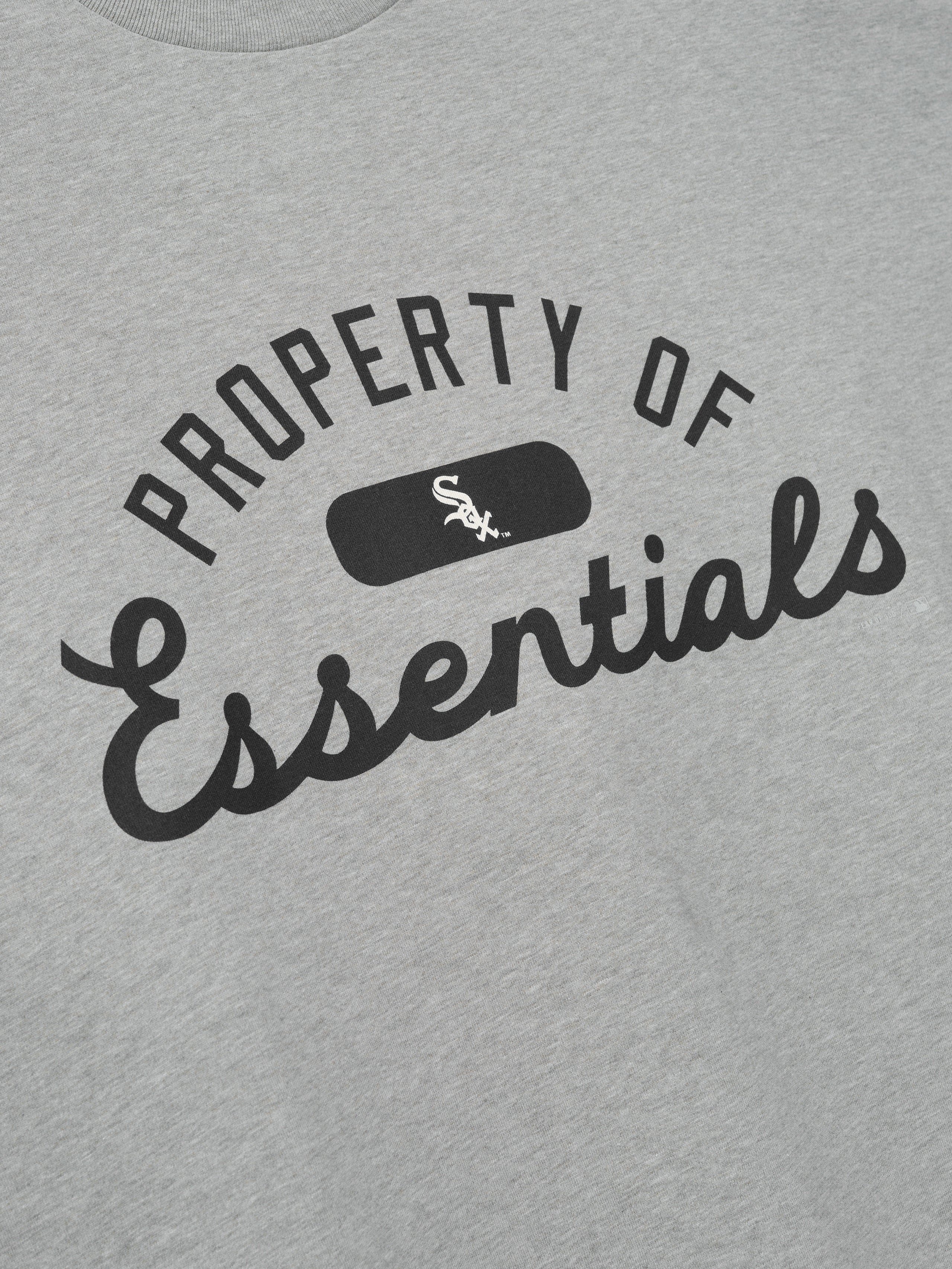 White Sox Merch Tee in light gray fabric featuring bold black "Property of Essentials" text with a small White Sox logo centered for a classic casual top.