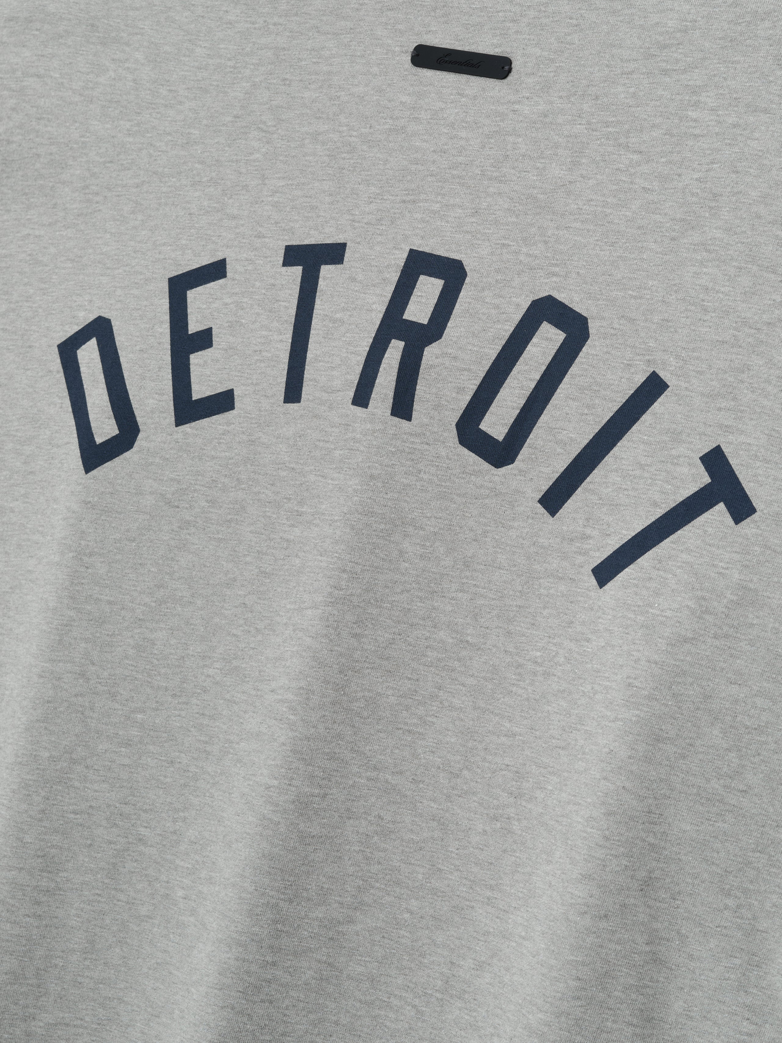 Gray sweatshirt with 'DETROIT' printed in navy blue on the back of a grey shirt.
