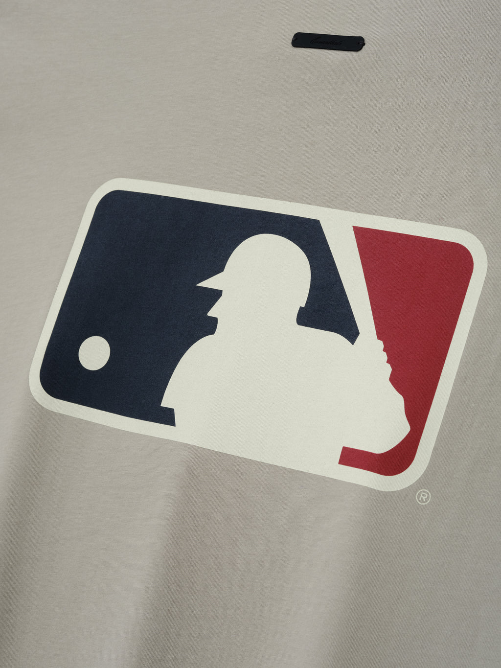 MLB Boxy Long Sleeve Tee in a soft gray shade featuring a large navy and red baseball silhouette logo on smooth fabric, designed for comfortable casual tops.