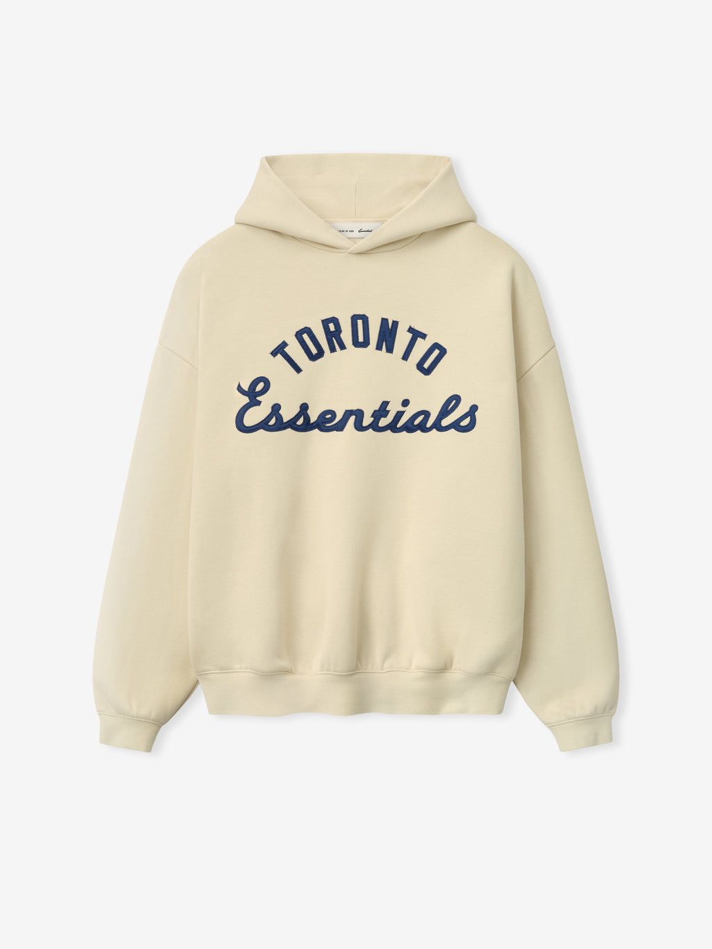 Blue Jays Sport Hoodie in a soft oatmeal shade featuring navy blue "Toronto Essentials" text in a classic script and arch design on comfortable outerwear fabric.