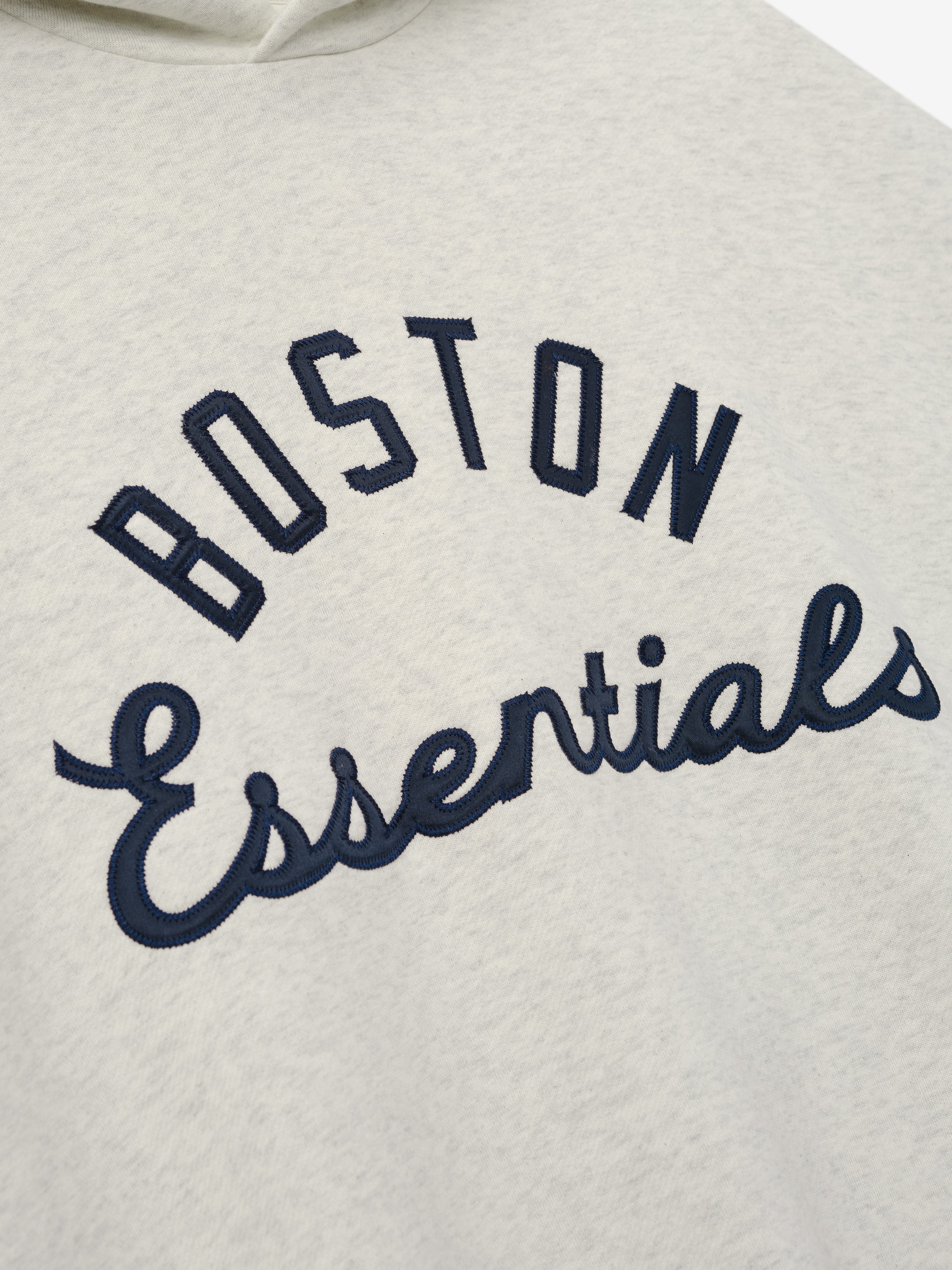 Red Sox Sport Hoodie in a light heather fabric with navy embroidered "BOSTON Essentials" text across the chest, designed as a comfortable and casual outerwear top.