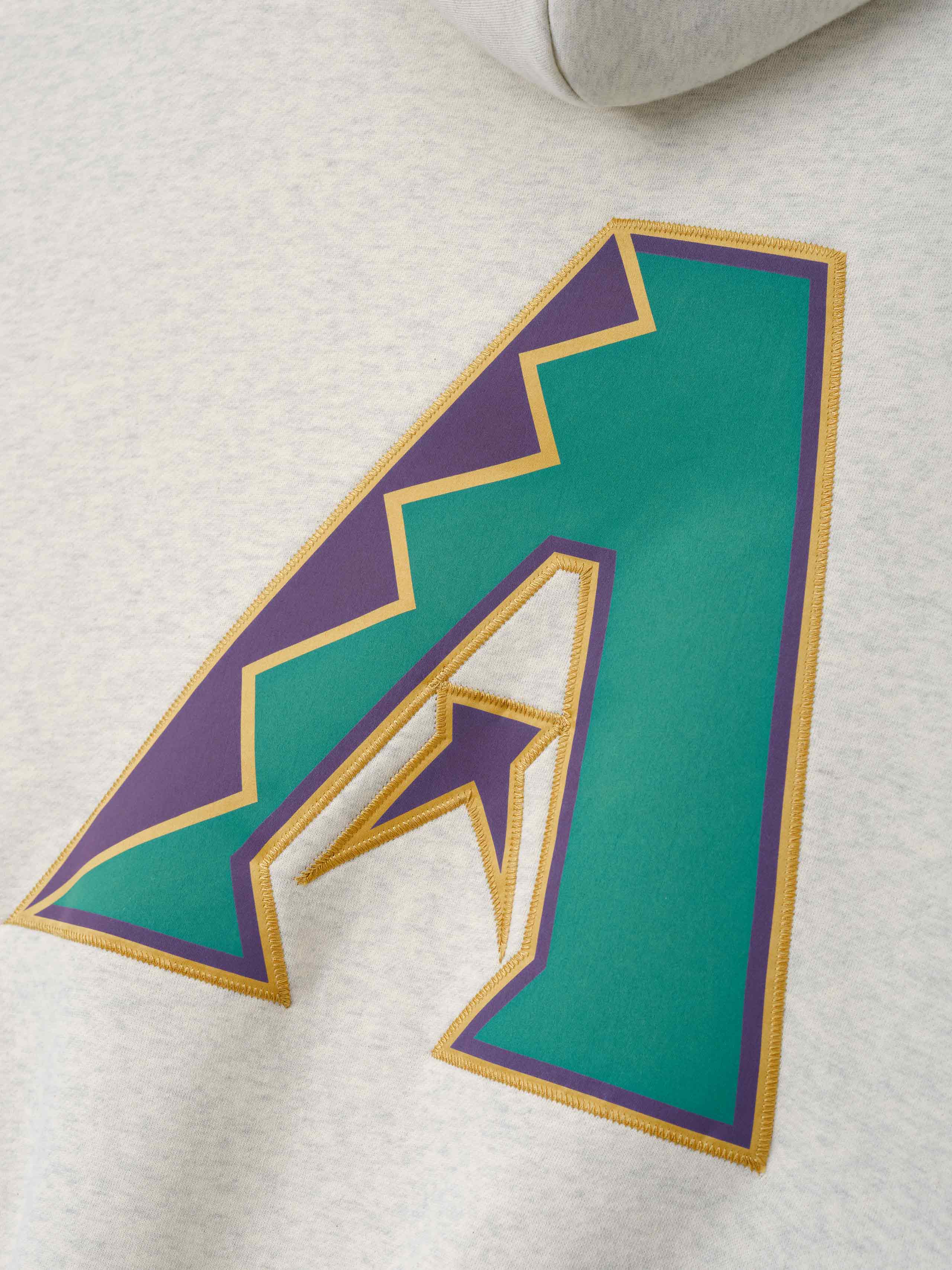Diamondbacks Sport Hoodie in a light oatmeal heather fabric featuring a large teal and purple stylized "A" applique with gold trim on soft outerwear material.