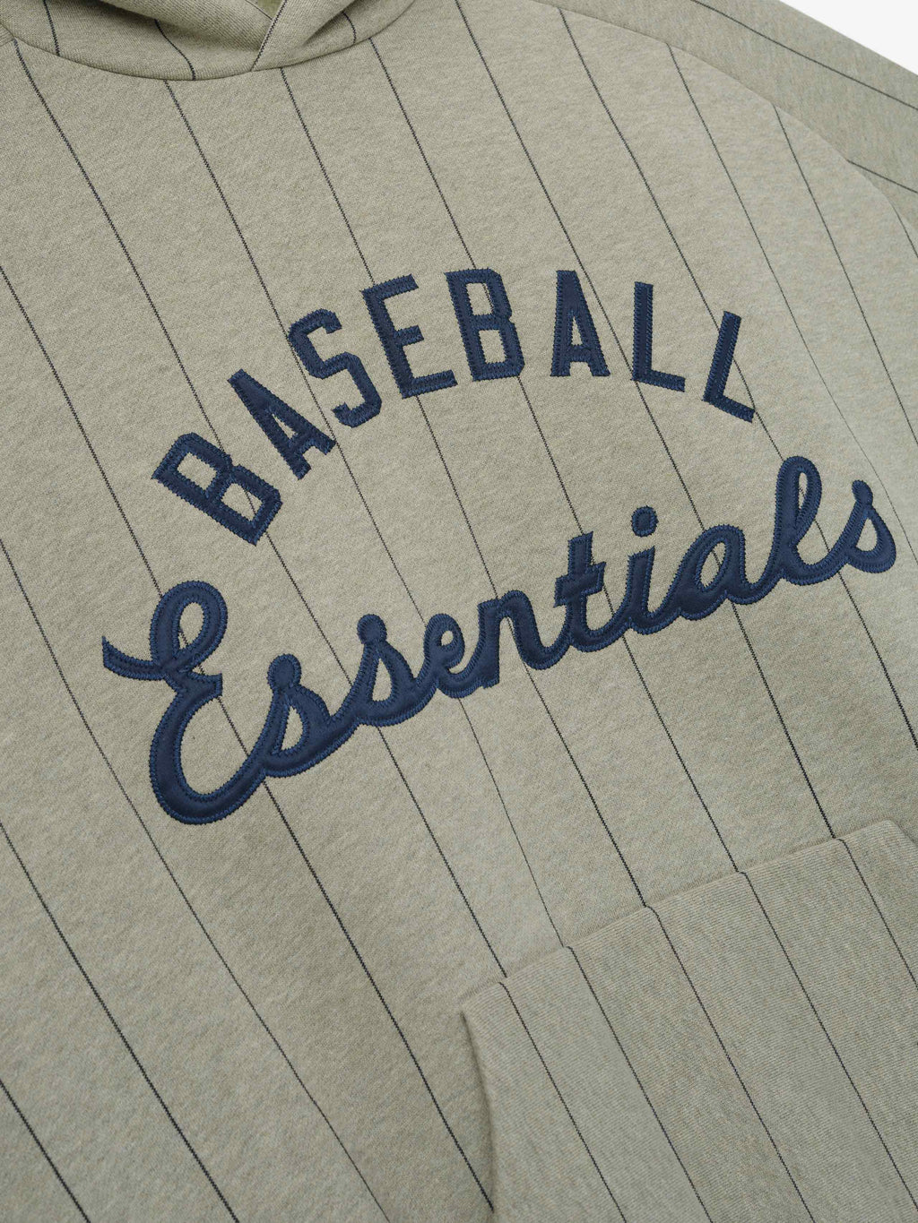 MLB Raglan Sport Hoodie in a muted seal heather shade with thin black pinstripes and navy embroidered "Baseball Essentials" text above the kangaroo pocket in soft outerwear fabric.