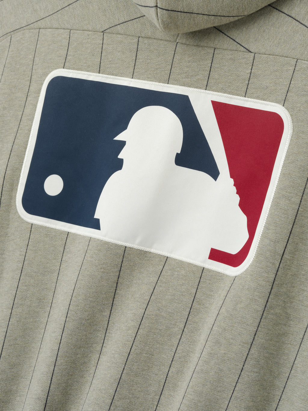 MLB Raglan Sport Hoodie in muted seal heather with thin vertical black pinstripes, featuring a large white baseball batter silhouette logo on a navy and red background on soft outerwear fabric.