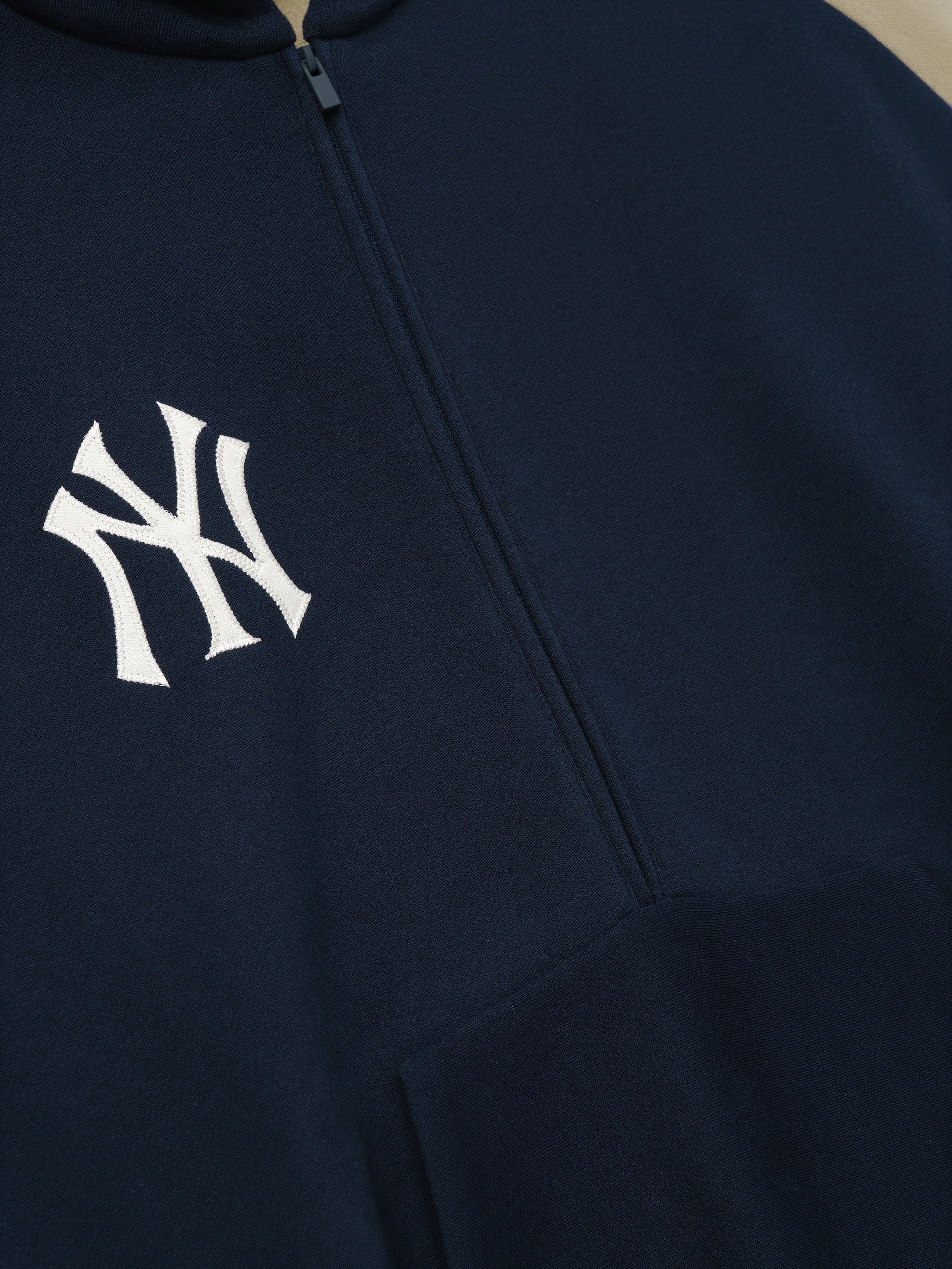 Navy blue hoodie with a  Yankees logo on the chest