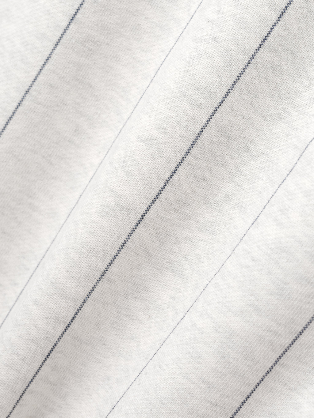 Close-up of a textured white fabric with diagonal lines