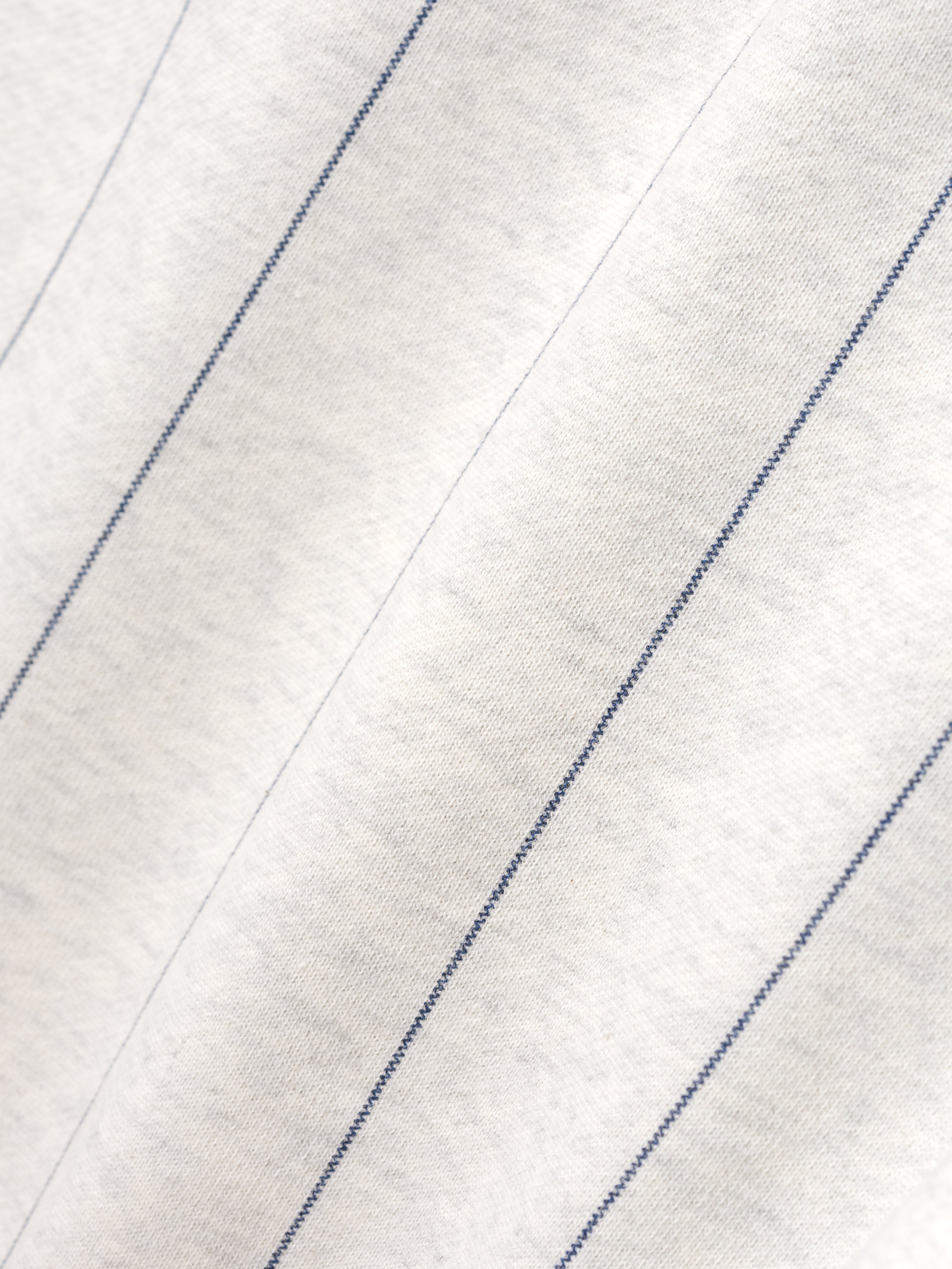 Close-up of a white fabric with blue stripes