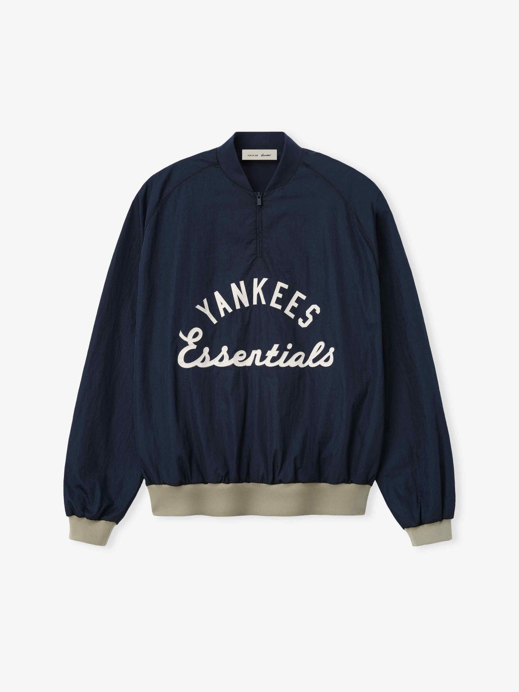 Yankees Half Zip Pullover in dark navy with beige ribbed cuffs and hem, featuring a half-zip front and white "Yankees Essentials" embroidered text across the chest.
