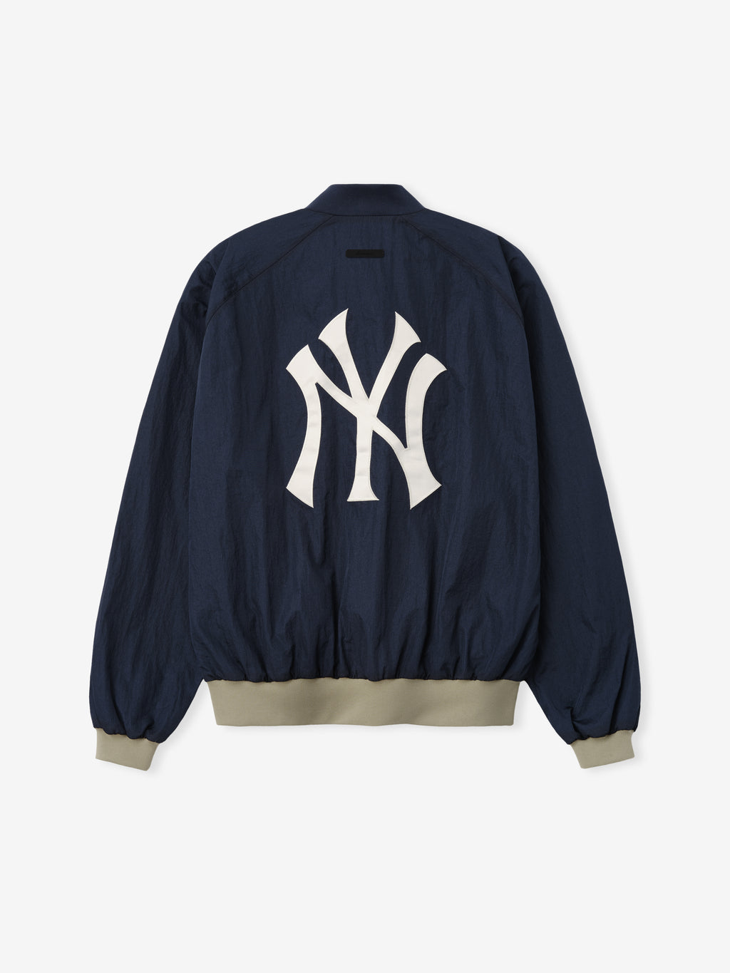 Yankees Half Zip Pullover in dark navy with contrasting beige ribbed cuffs and hem, featuring a large white Yankees logo centered on the back for a sporty outerwear look.