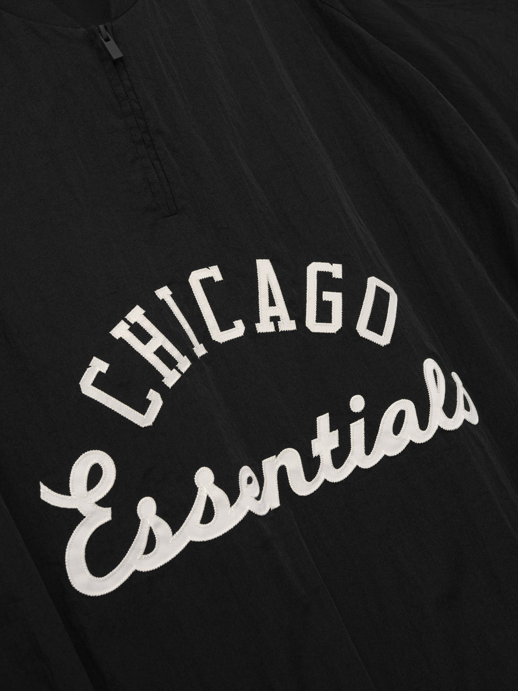 White Sox Half Zip Pullover in black fabric featuring white "Chicago Essentials" embroidered script on the chest with a quarter zip for versatile casual outerwear.