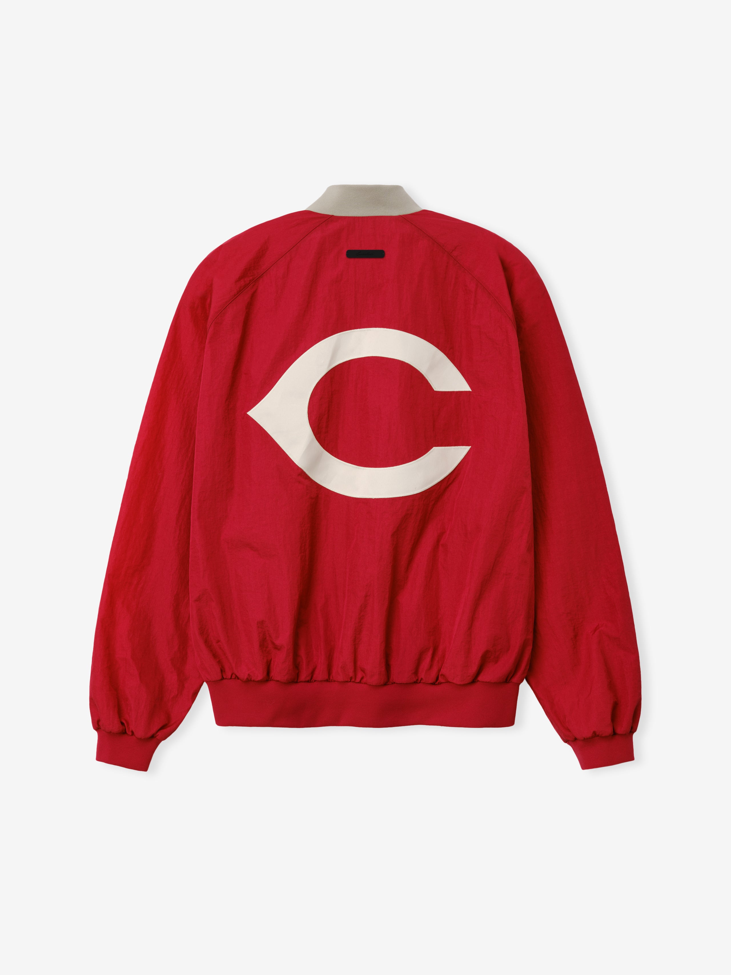 Reds Half Zip Pullover in a bold stone red color featuring a large white Cincinnati-inspired emblem on the back, designed as a lightweight outerwear piece with elasticated cuffs and hem.