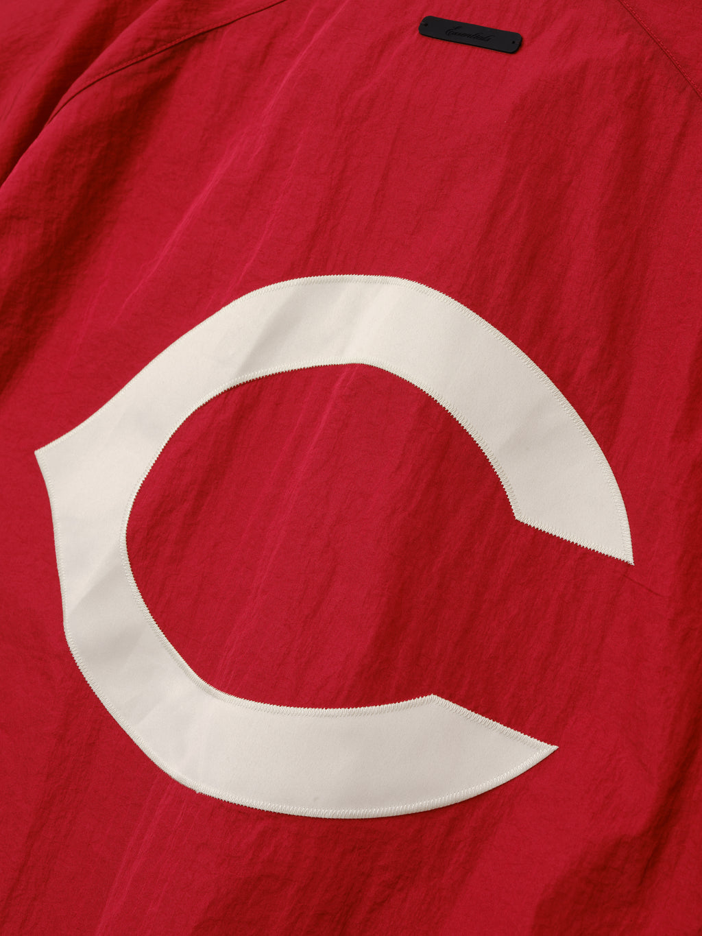 Reds Half Zip Pullover in a deep red tone featuring a large white "C" graphic stitched on textured lightweight outerwear fabric.