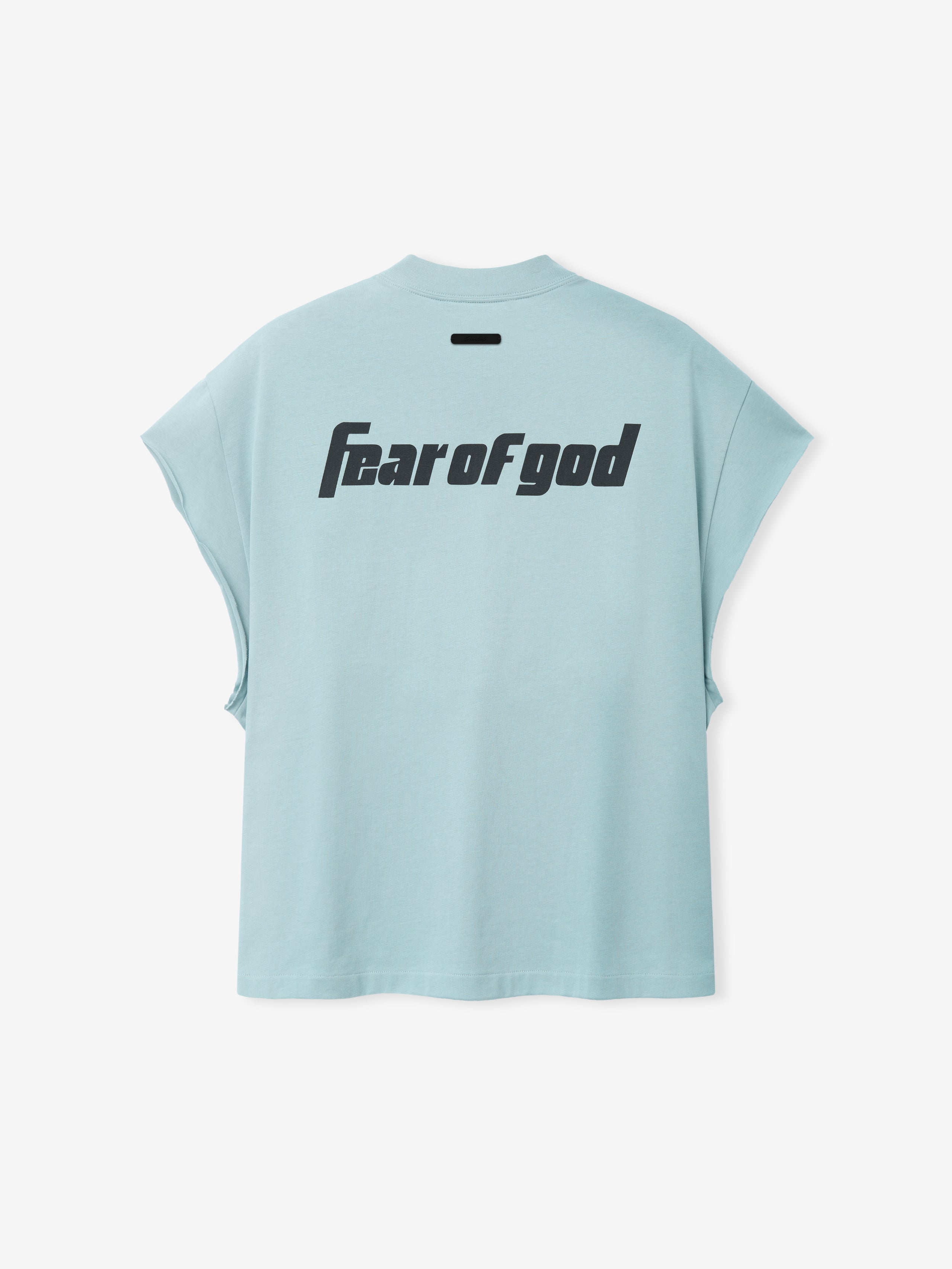 Back view of Fear Of God X Franklin 90s Cutoff in soft stone blue featuring bold black "Fear of god" text on smooth fabric with wide armholes and a relaxed fit.