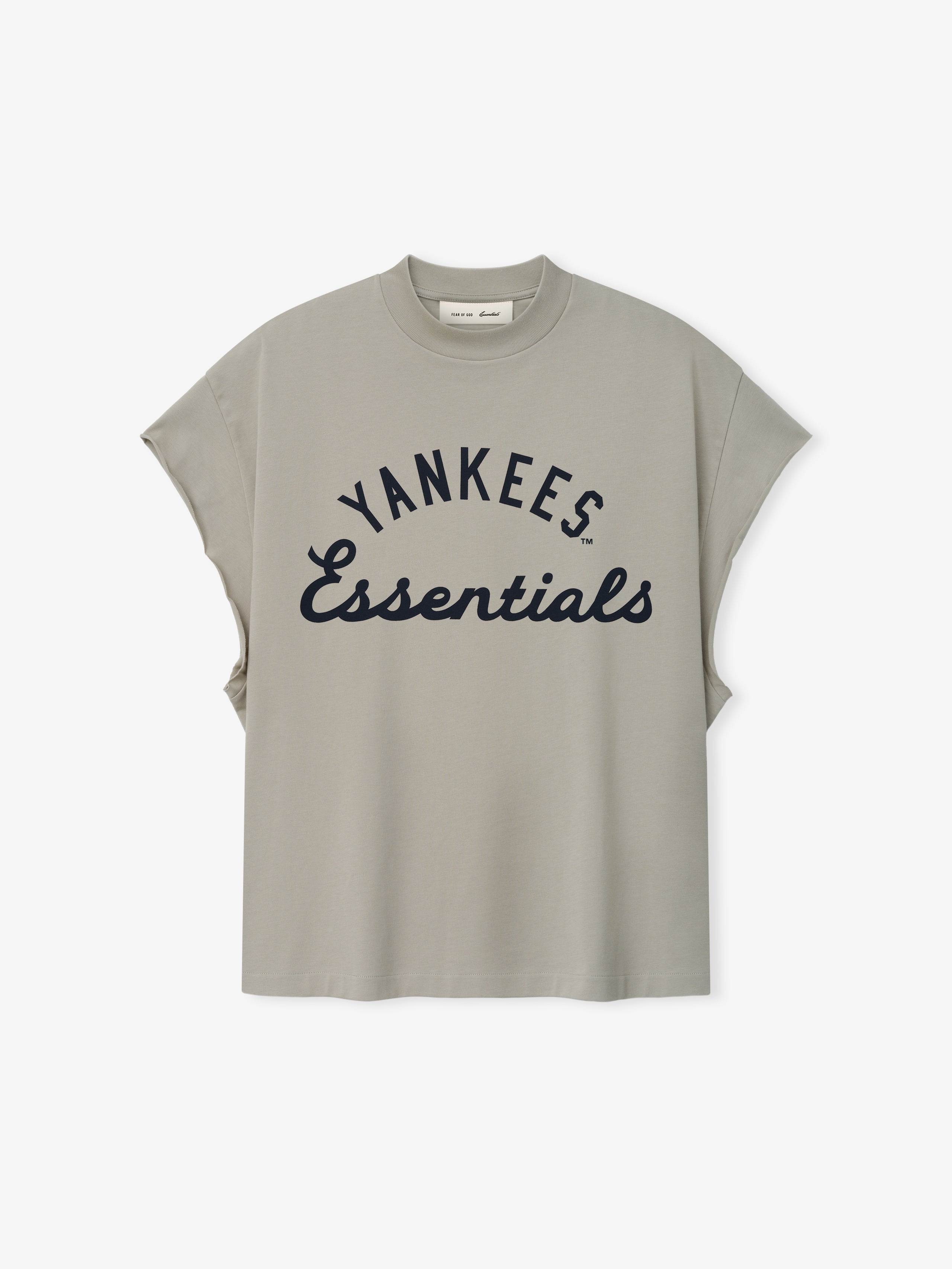 Yankees 90s Cut Off in muted gray featuring a relaxed fit with wide arm openings and bold navy "Yankees Essentials" text across the front on a soft cotton top.