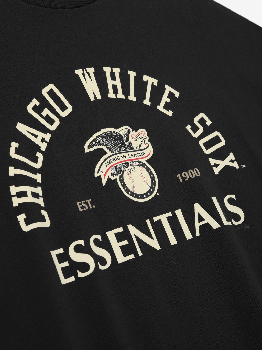 Close-up of the front of the White Sox AL Merch Tee in black, featuring a vintage-inspired Chicago White Sox graphic with an eagle, baseball, and bold "ESSENTIALS" text.