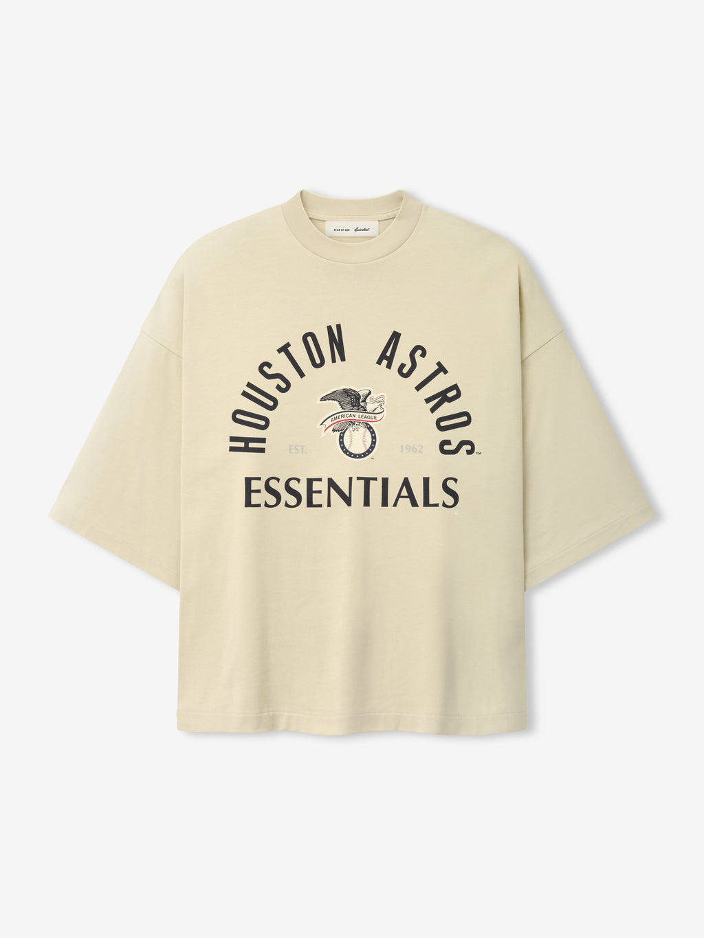 Cream-colored oversized short-sleeve top featuring black "Houston Astros Essentials" text and a vintage-style eagle graphic, part of the Astros Al Merch Tee collection.