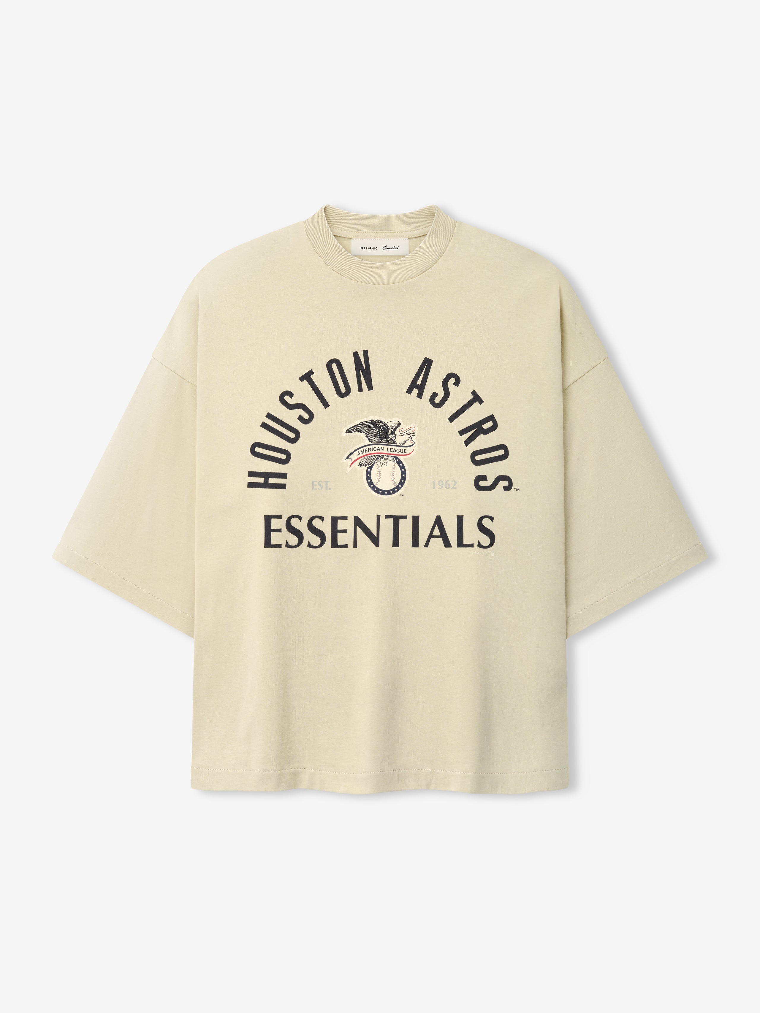 Cream-colored oversized short-sleeve top featuring black "Houston Astros Essentials" text and a vintage-style eagle graphic, part of the Astros Al Merch Tee collection.