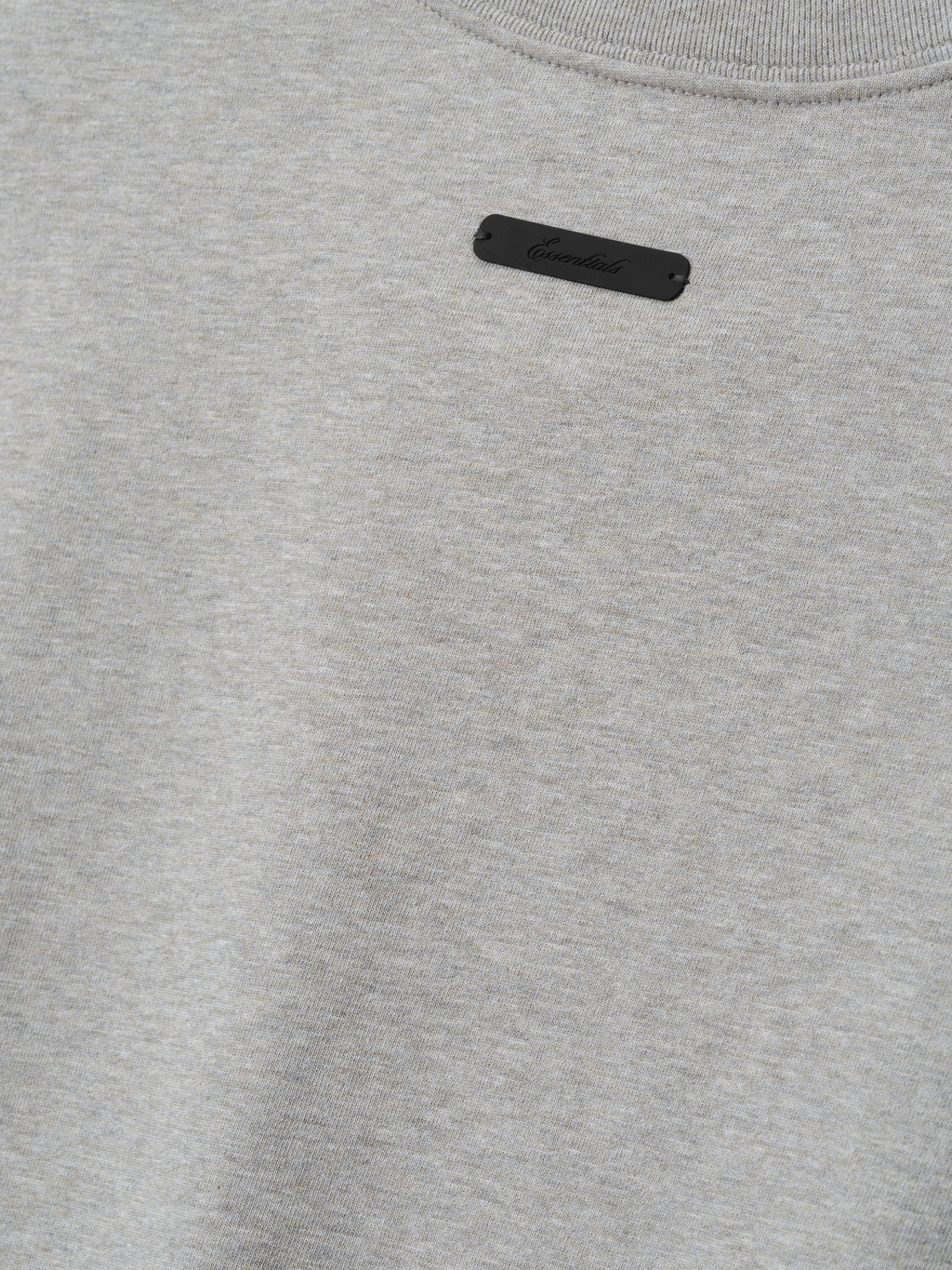 Rangers AL Merch Tee in a soft concrete heather fabric featuring a small black branded patch near the neckline, designed as a minimalist casual top.