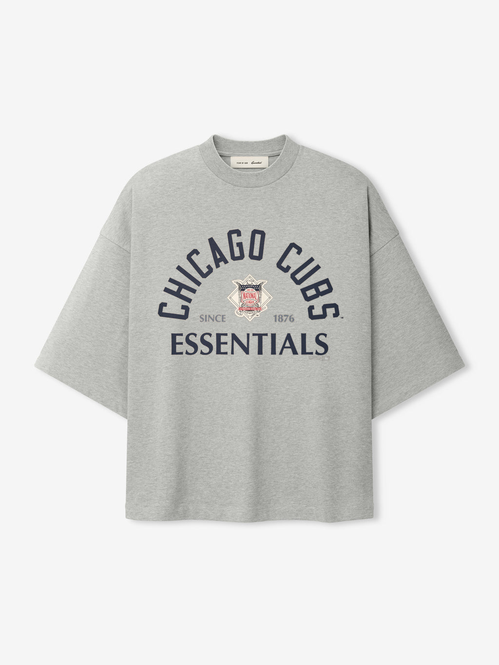 Light grey oversized short-sleeve top featuring navy blue "Chicago Cubs Essentials" text and a vintage-style emblem with "Since 1876" detail, part of the Cubs NL Merch Tee collection.