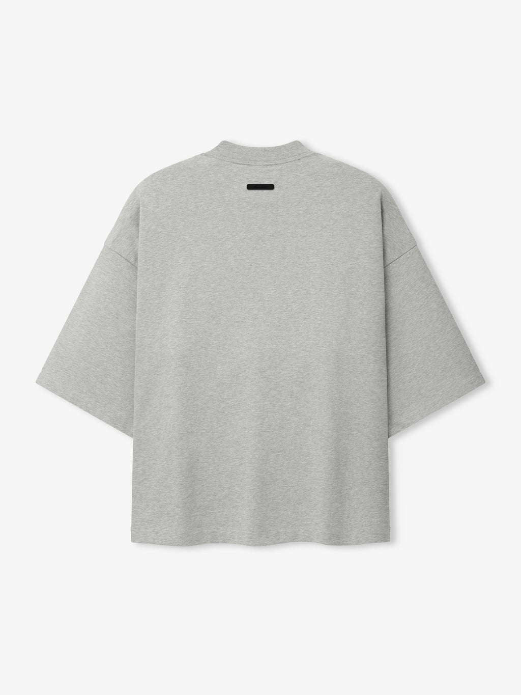 Back view of a light grey oversized short-sleeve top with dropped shoulders and a small black rectangular detail near the neckline, part of the Cubs NL Merch Tee collection.