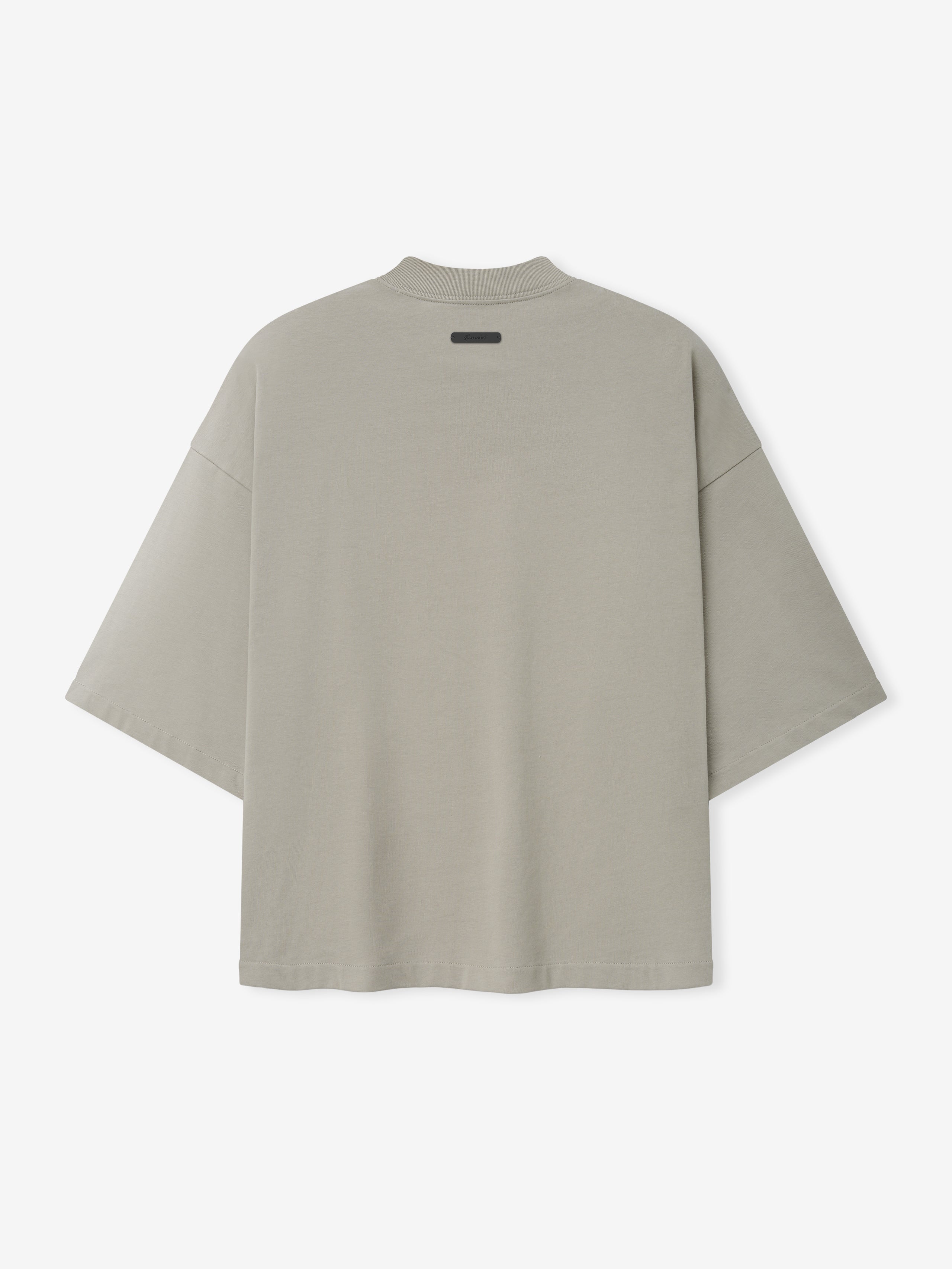 Reds NL Merch Tee in a muted gray-beige tone featuring an oversized fit with dropped shoulders and a small black label detail near the upper back on soft fabric top.
