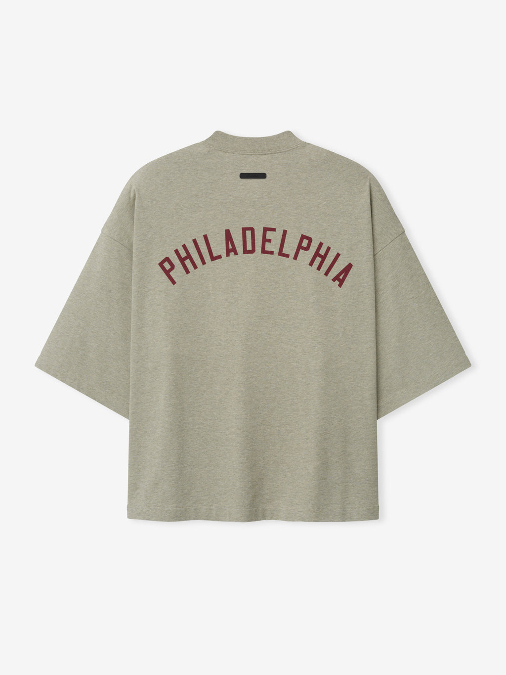 Phillies Merch Tee in a soft muted green shade featuring bold maroon "PHILADELPHIA" text arched across the back, designed with a relaxed fit and wide sleeves for casual comfort.
