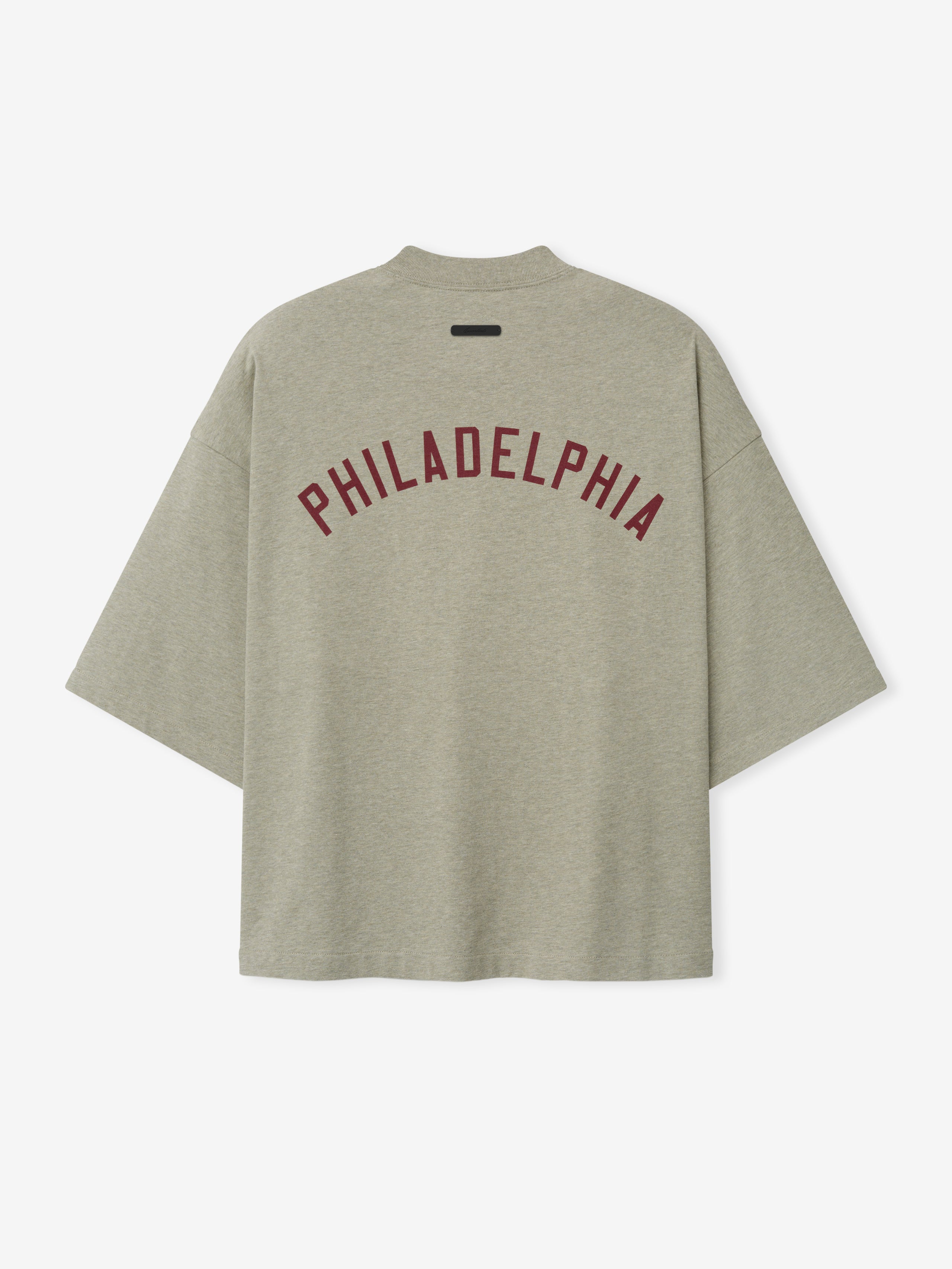 Phillies Merch Tee in a soft muted green shade featuring bold maroon "PHILADELPHIA" text arched across the back, designed with a relaxed fit and wide sleeves for casual comfort.