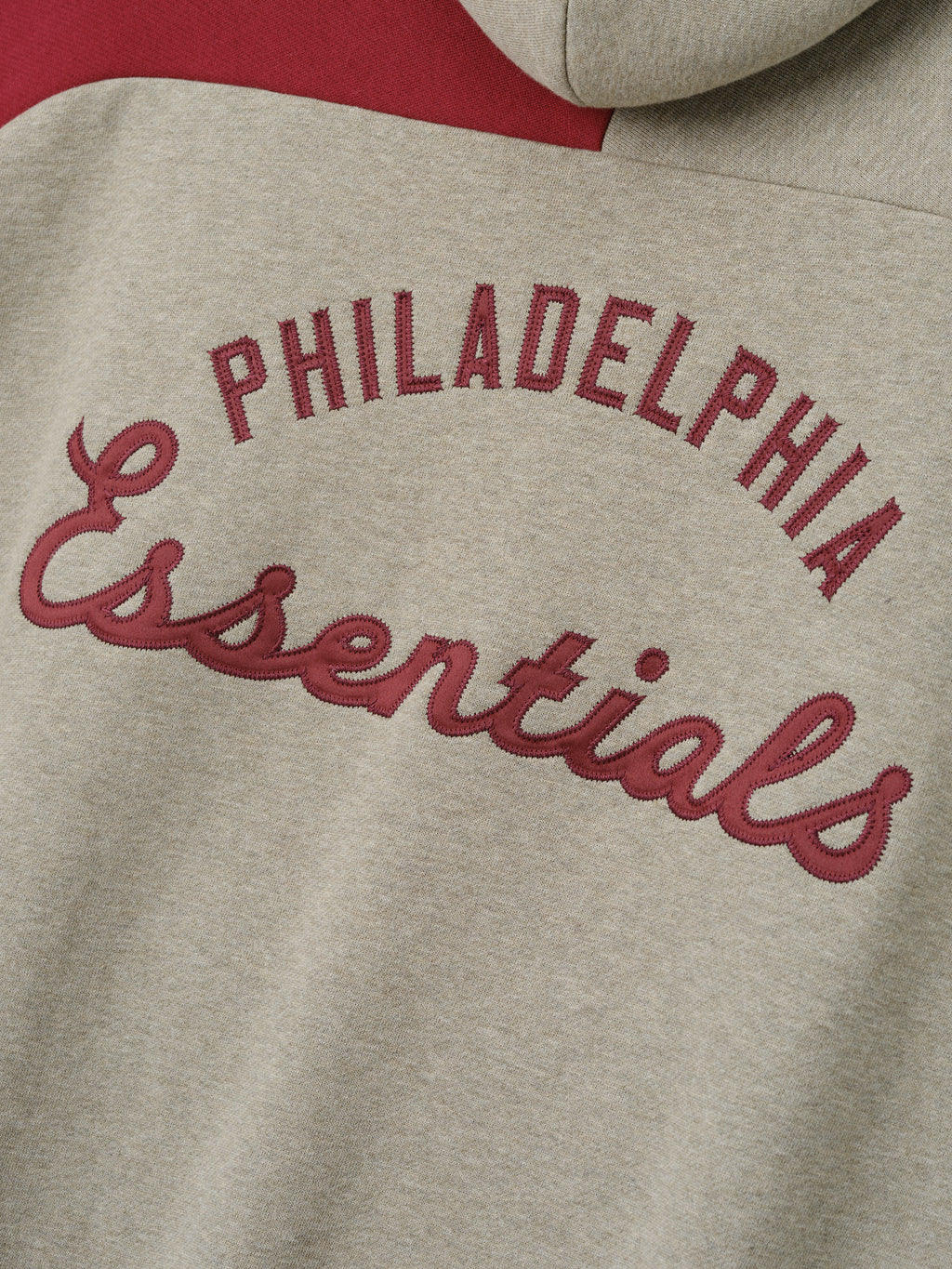Phillies Raglan Half Zip Sport Hoodie featuring raised maroon "Philadelphia Essentials" embroidery on a soft beige fabric with a contrasting deep red panel.