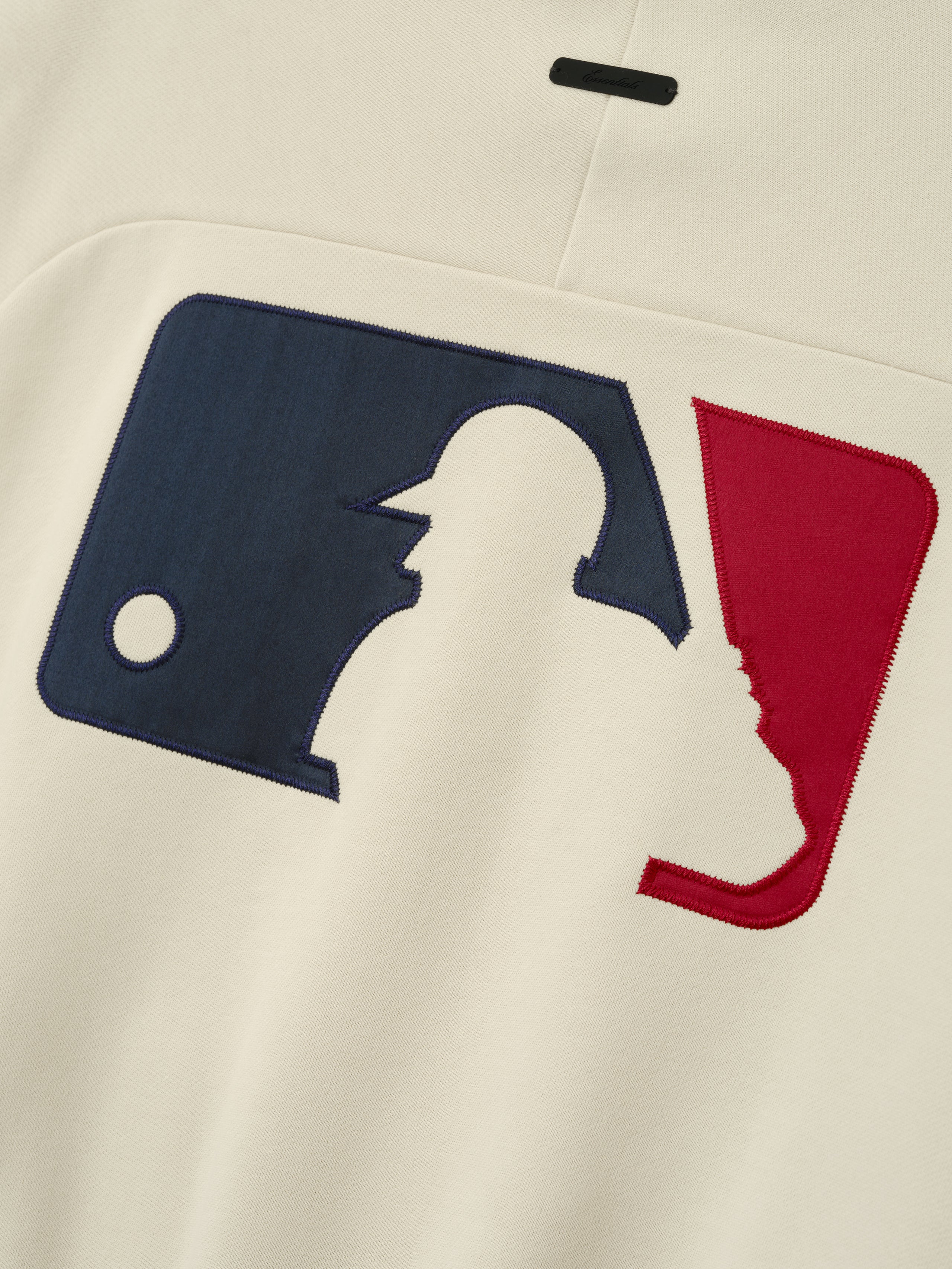 Mlb Sport Crewneck in a soft oat tone featuring a large stitched applique of a navy and red baseball player graphic on the front, highlighting a sporty and casual design.