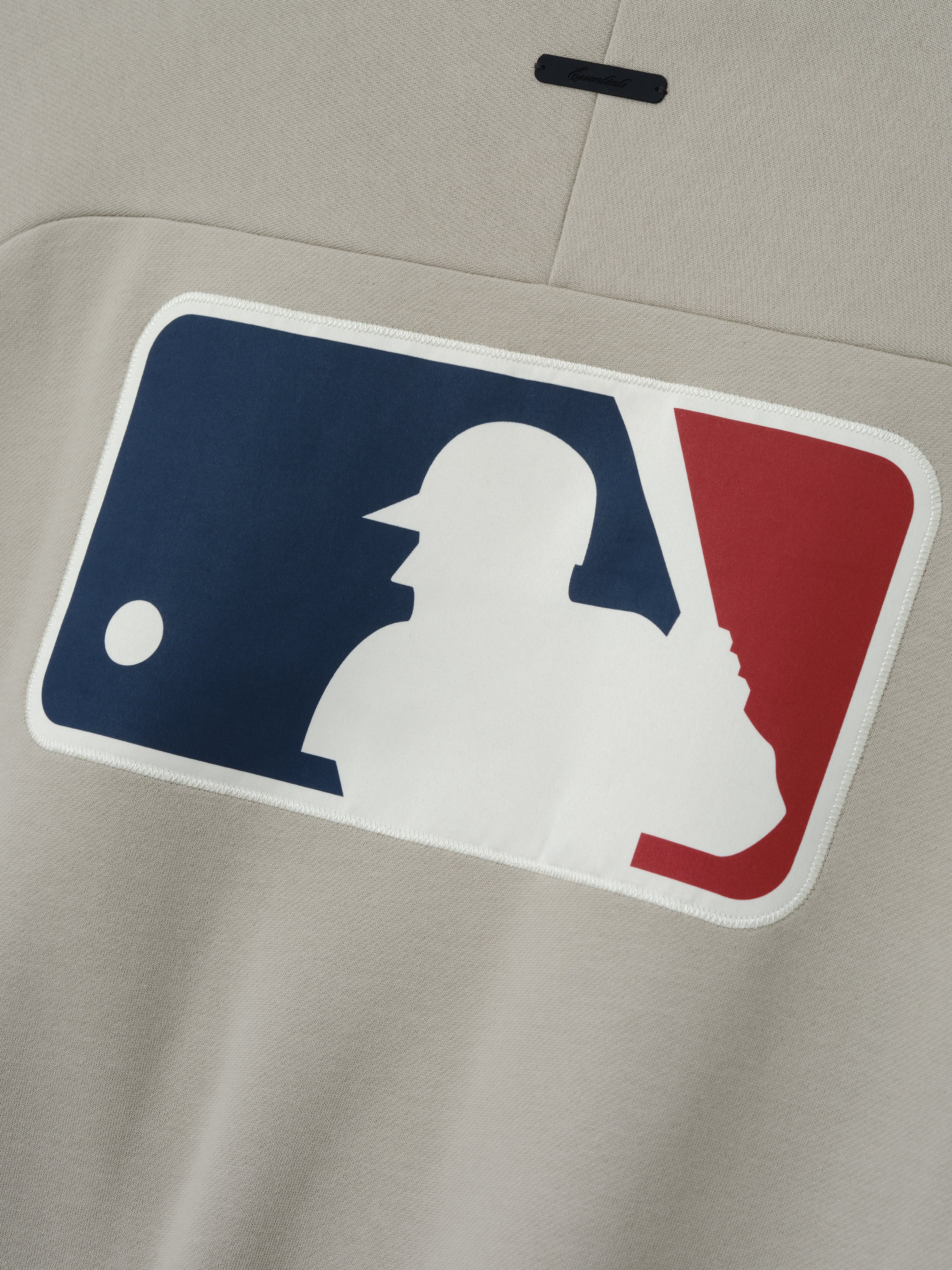 Mlb Sport Crewneck in a muted beige tone featuring a large embroidered MLB baseball player logo patch on the front, crafted from soft fabric for a comfortable fit.