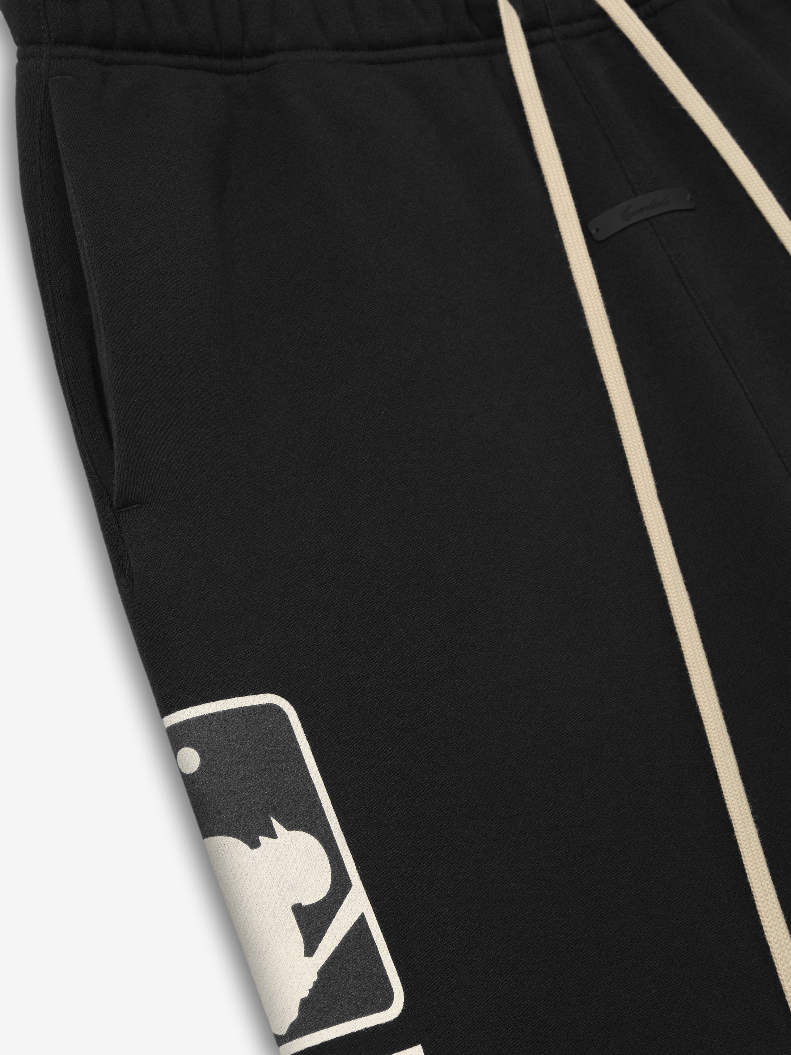 Black MLB Lounge Sweatpant featuring contrasting cream-colored drawstrings and a partially visible large cream baseball silhouette logo on soft comfortable fabric.