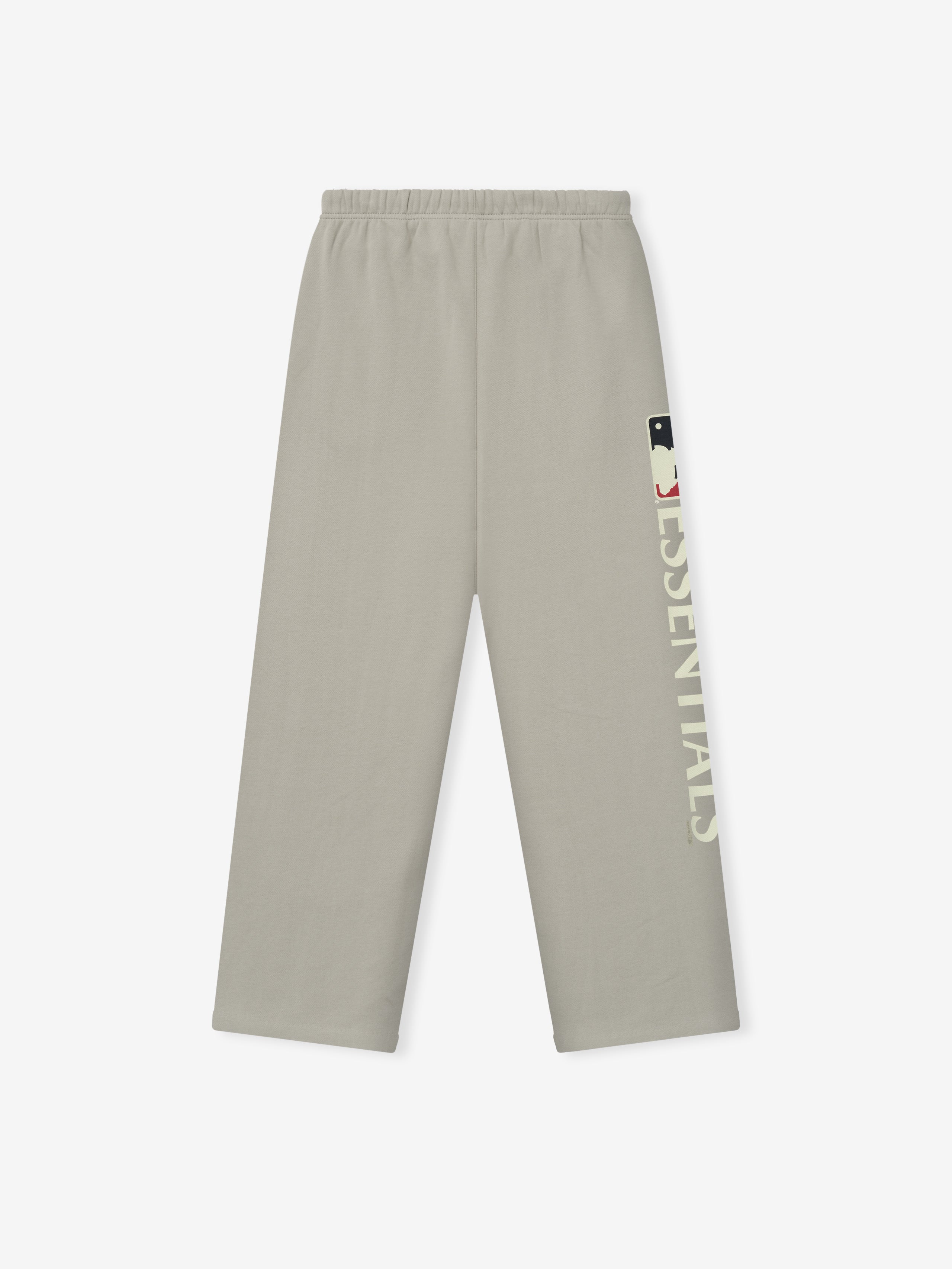 Mlb Lounge Sweatpant in muted beige with a relaxed fit, elastic waistband, and vertical bold "ESSENTIALS" text accompanied by a small logo graphic on the side leg.