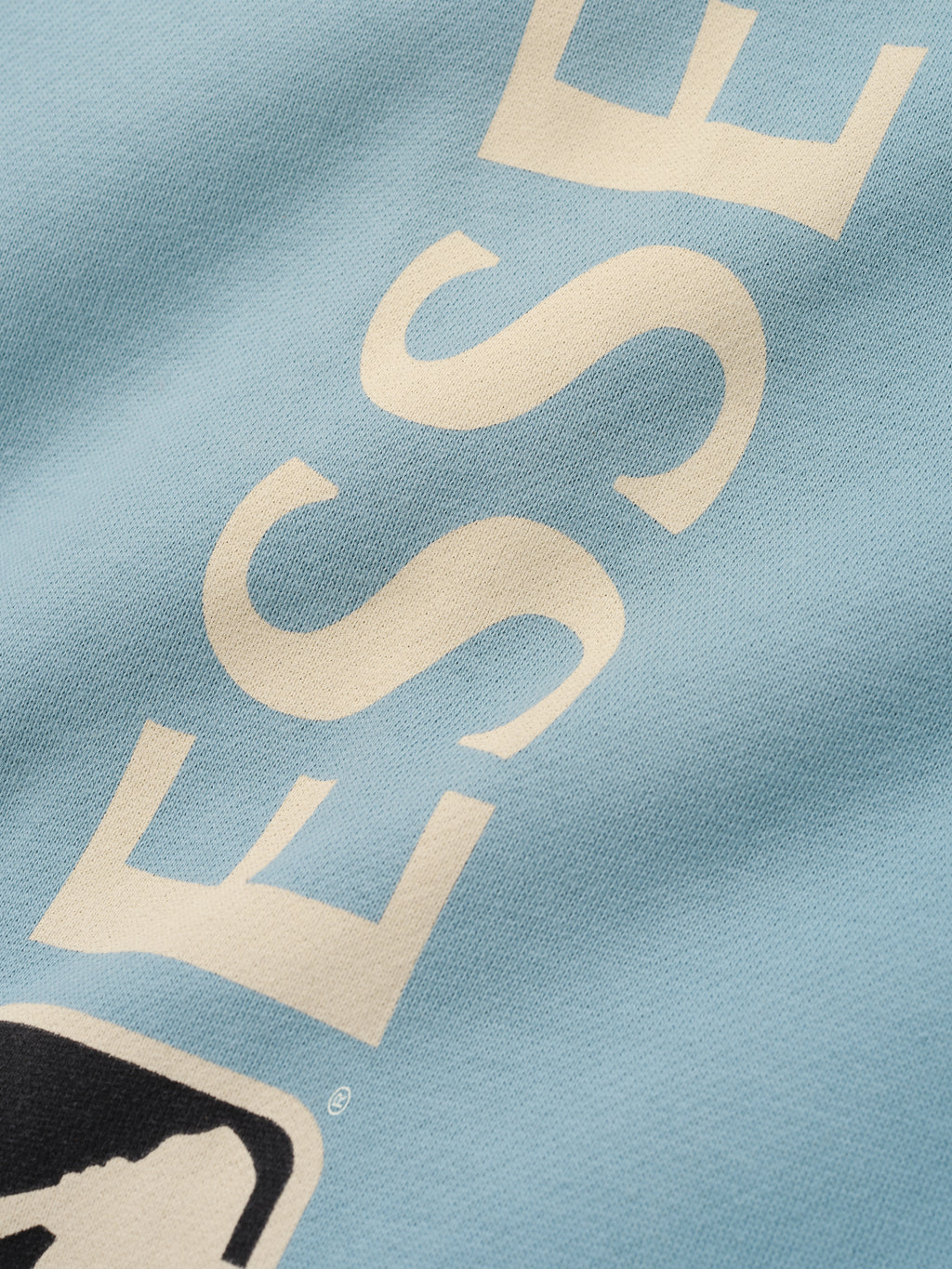 Mlb Lounge Sweatpant in muted stone blue fabric featuring a soft texture and cream-colored bold lettering with a partial logo detail on casual bottoms.